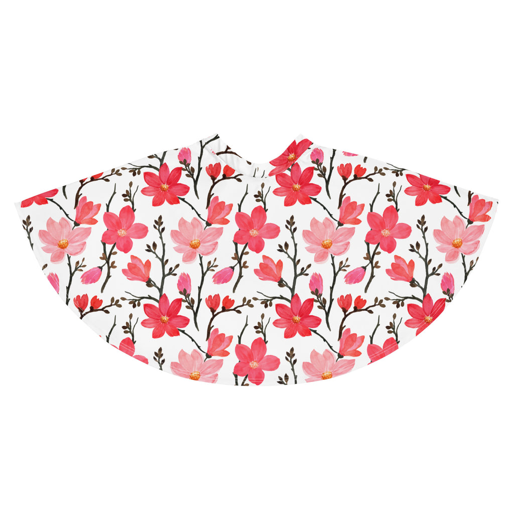 A white women’s skater skirt with vibrant pink and red magnolia blossoms on dark branches made from recycled fabric