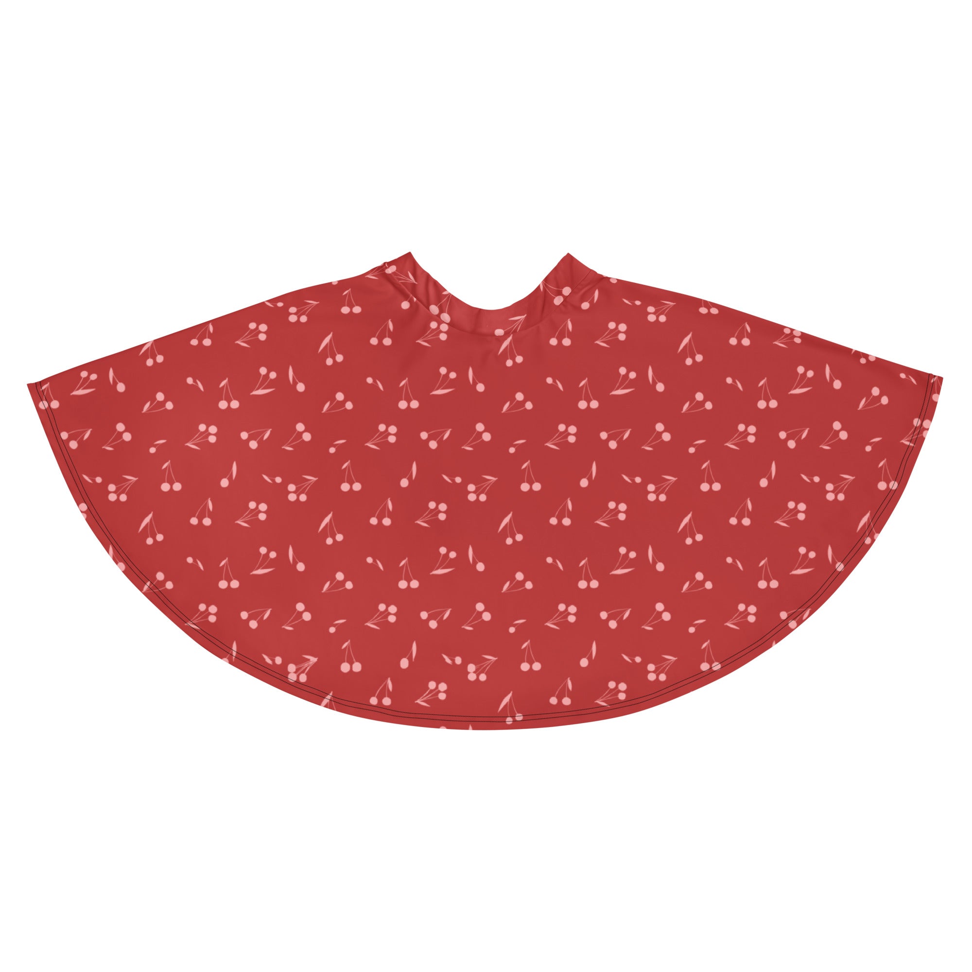 A flowy red cherry patterned cape in soft recycled fabric perfect for stylish layering and sun protection