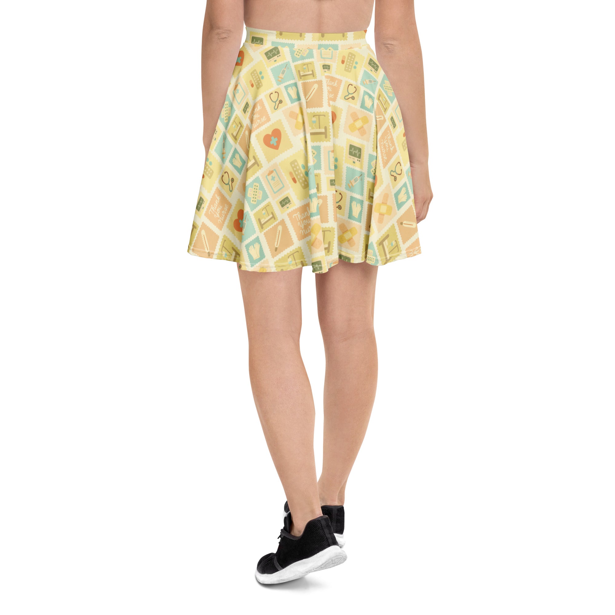 A yellow pleated nurse icon skater skirt with pastel medical and school patterns made from recycled fabric with UPF 50+
