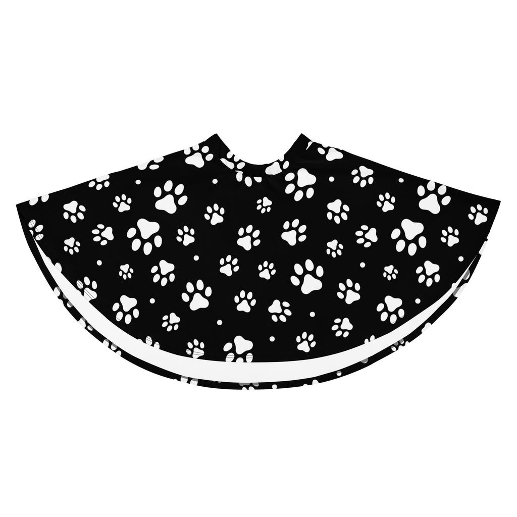 Black pet grooming cape with white paw print pattern and white trim designed as a women’s paw print skater skirt with upf 50 and recycled fabric