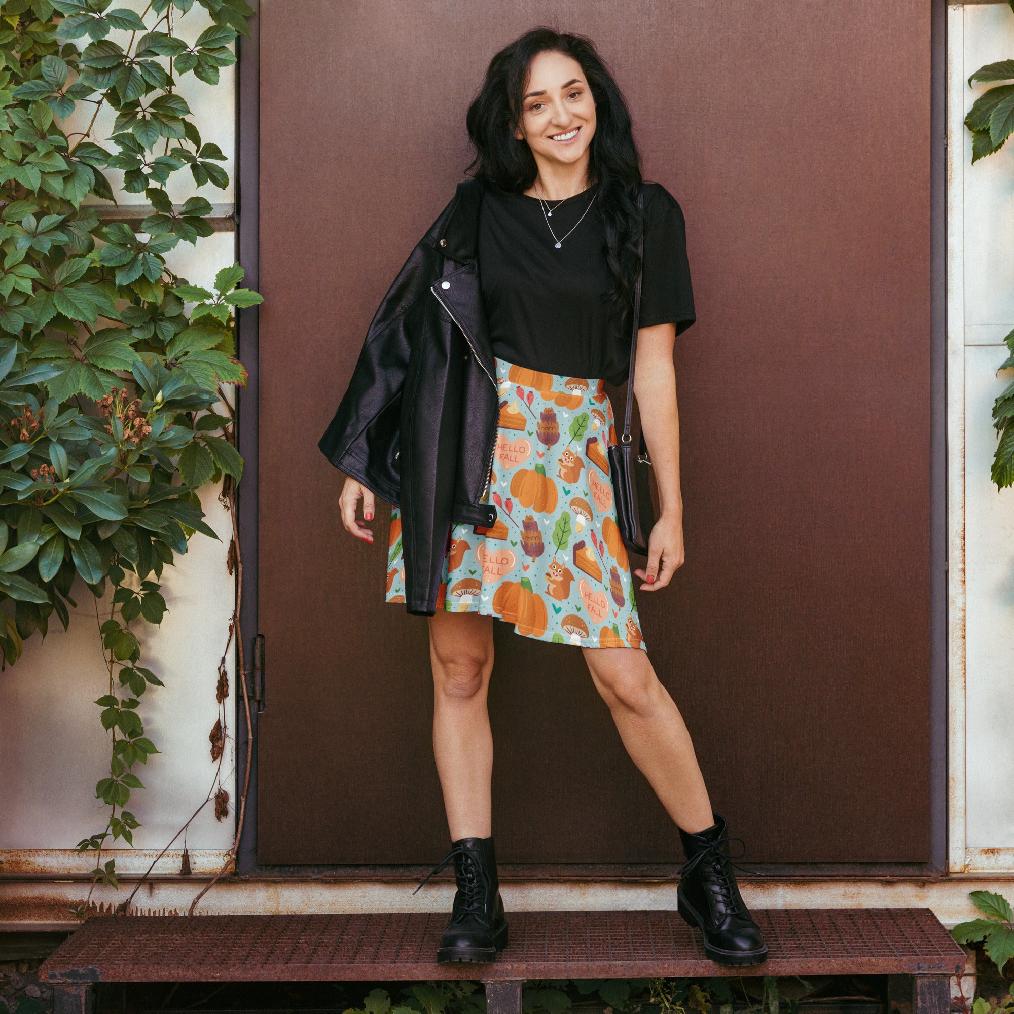A black leather jacket with zipper closure and silver hardware paired with a women’s hello fall skater skirt