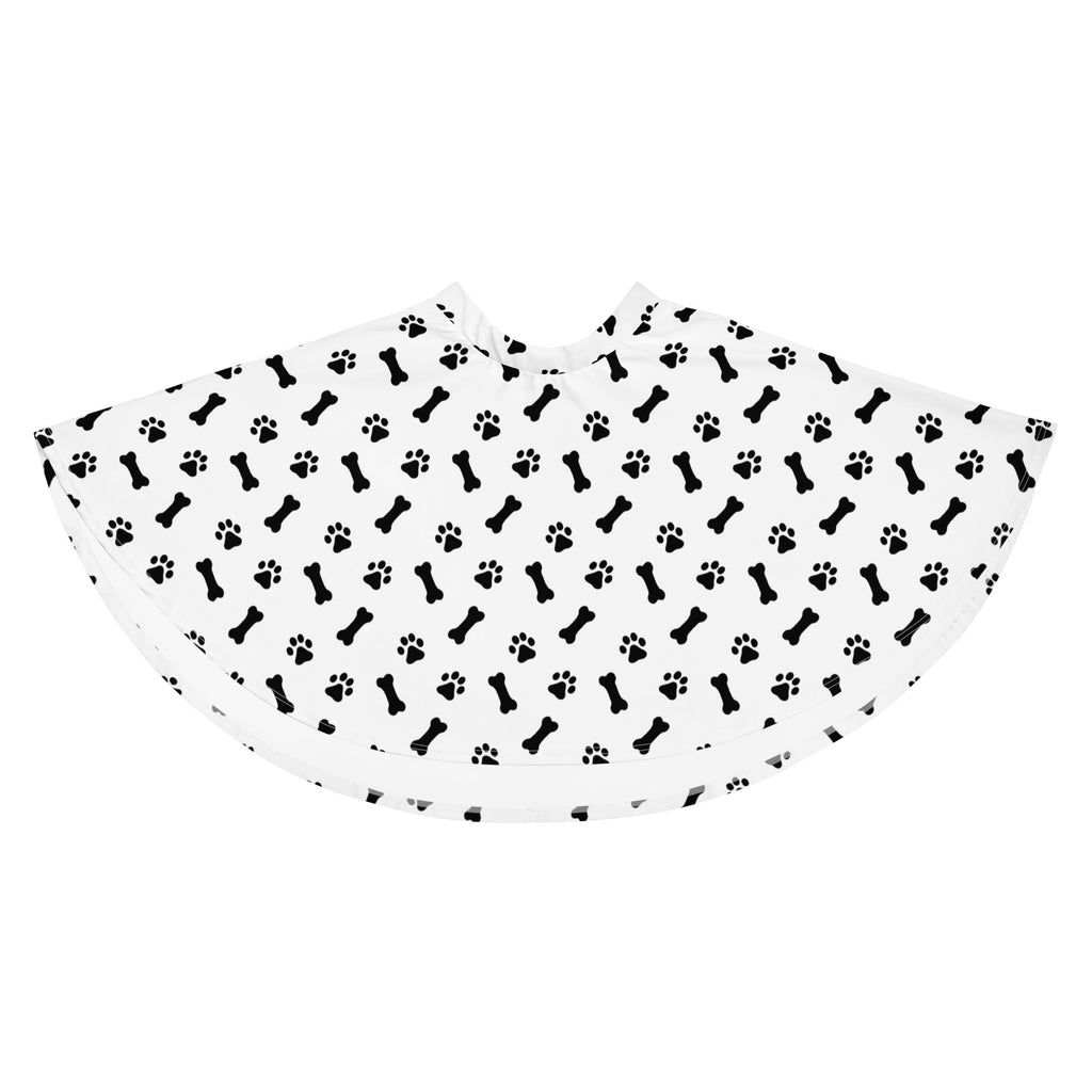 White pet grooming cape with black bone and paw print pattern made from recycled fabric with upf 50+ protection