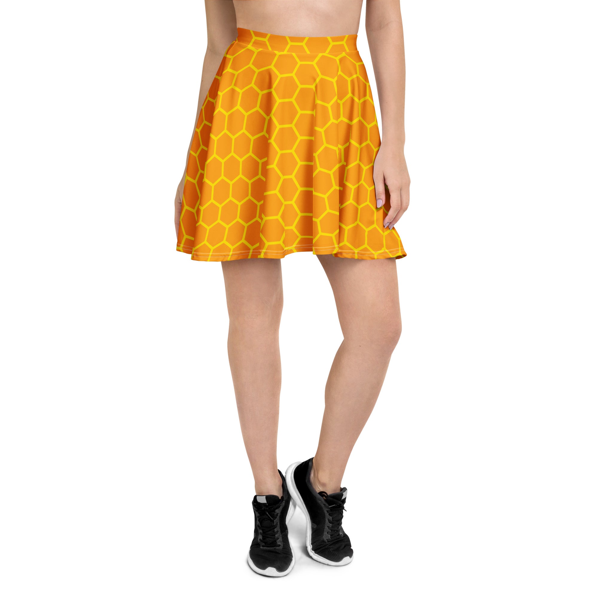 A vibrant orange women’s honeycomb skater skirt with bold yellow pattern flowy high waisted UPF 50 plus recycled fabric