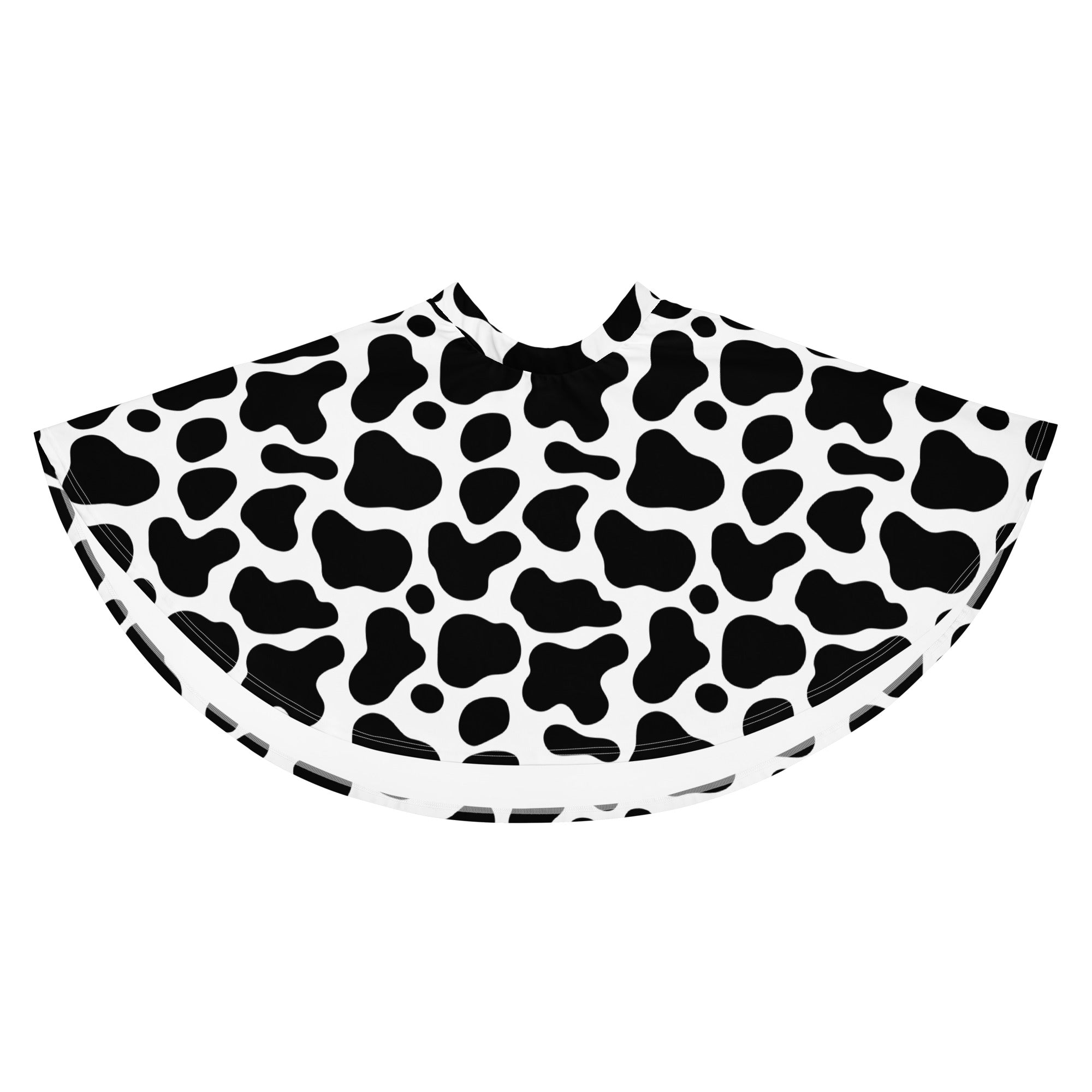 Black and white cow print barber cape made with recycled fabric featuring flowy design and high waisted fit