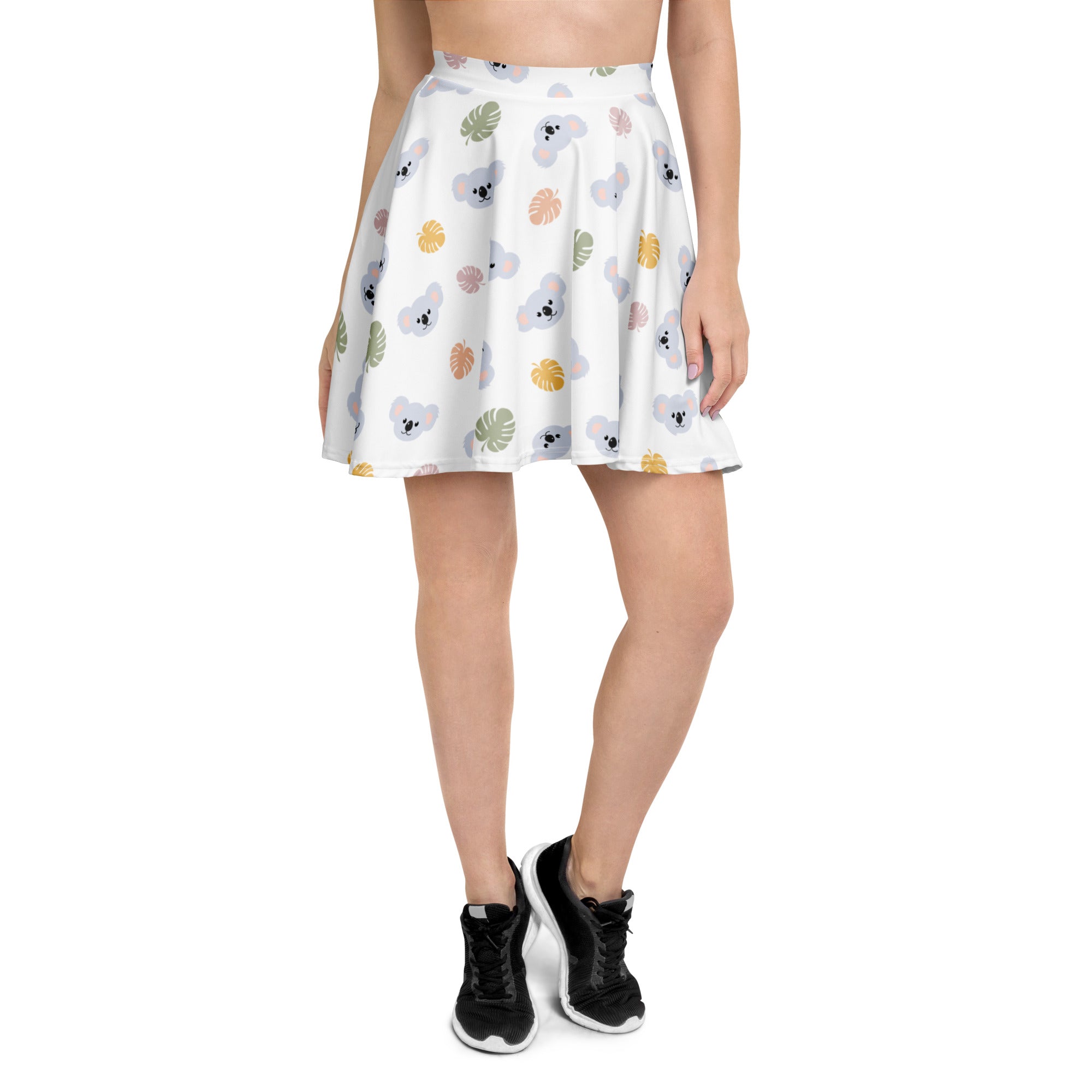 White flared women’s koala print skater skirt with colorful tropical leaves made from recycled fabric with upf 50+