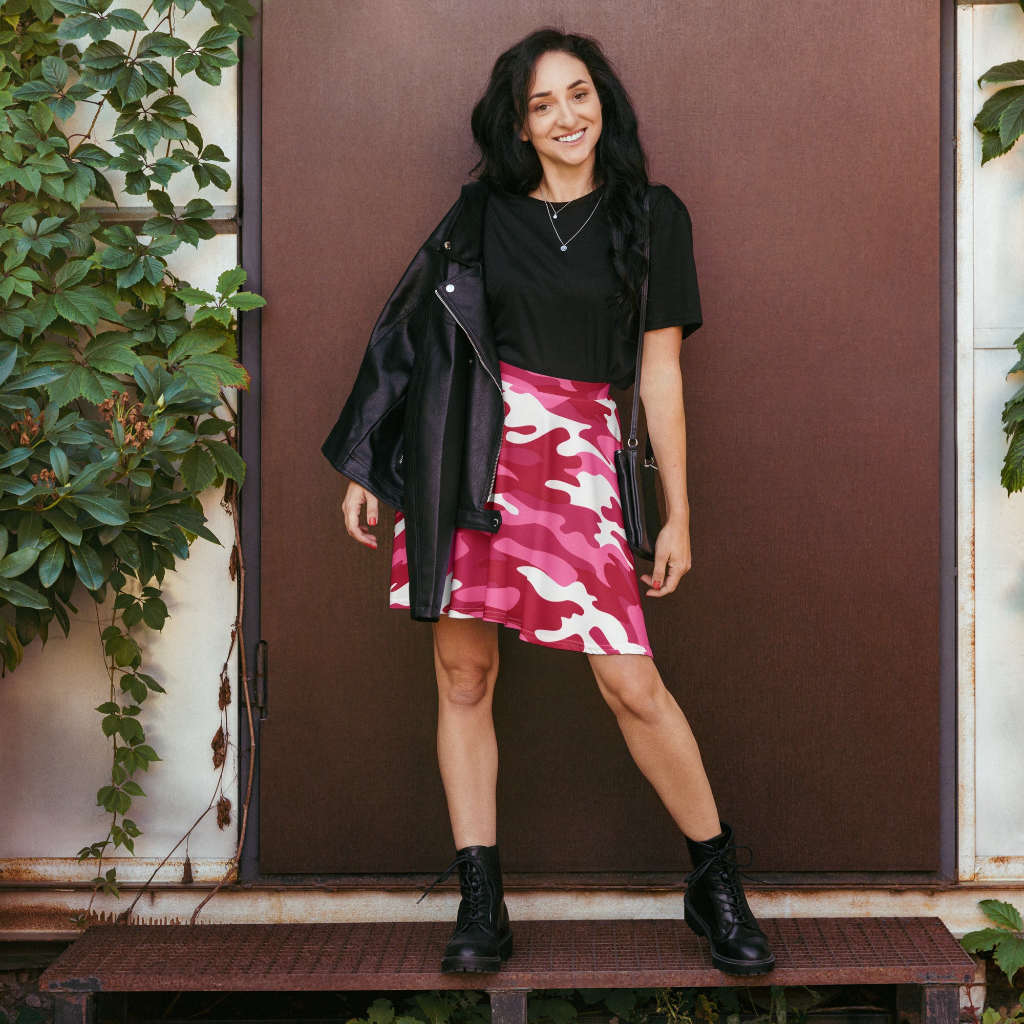 A vibrant hot pink and white camouflage skater skirt with a flowy high waisted silhouette made from recycled fabric