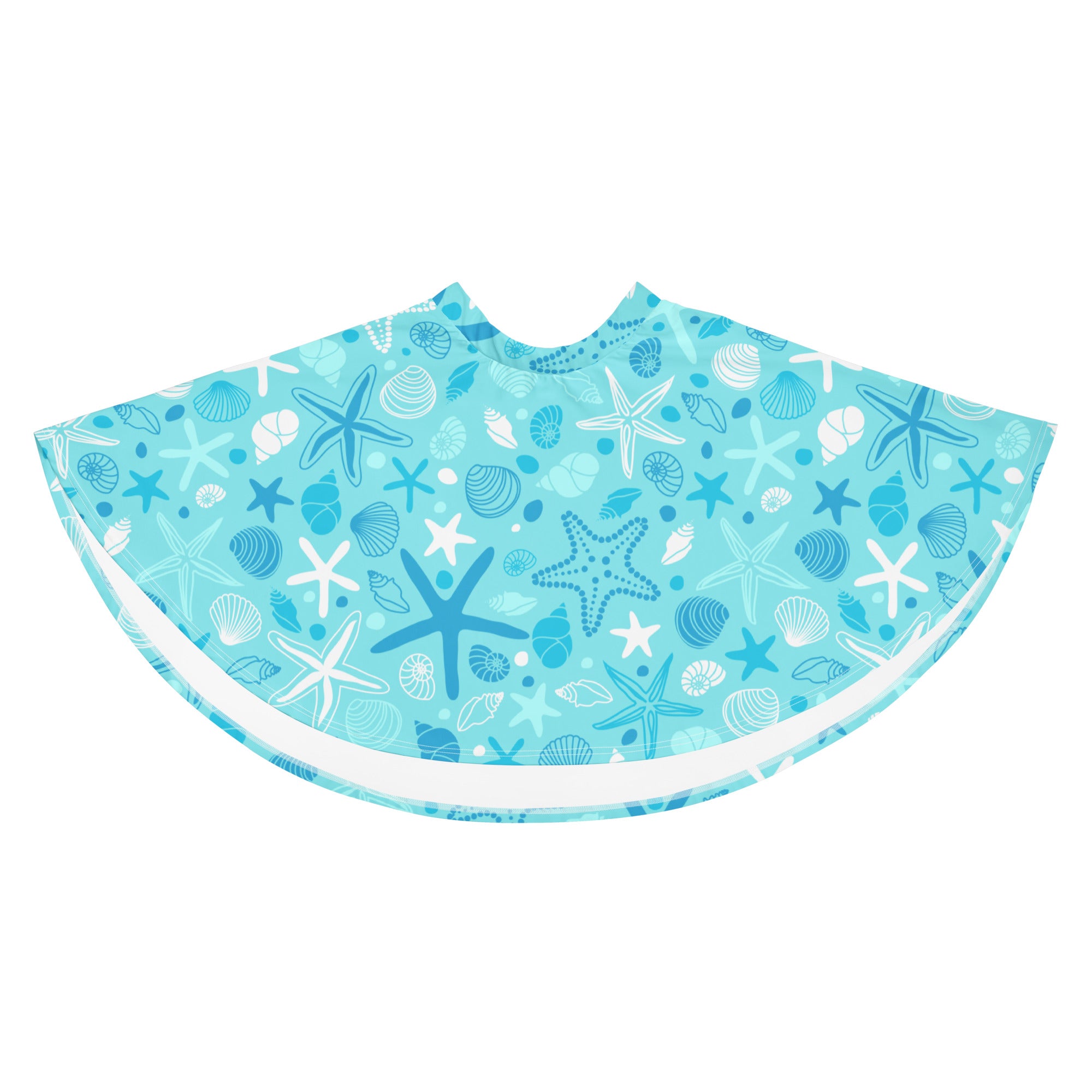 A light blue beach poncho with starfish and seashell patterns in blue white and gray made from recycled fabric