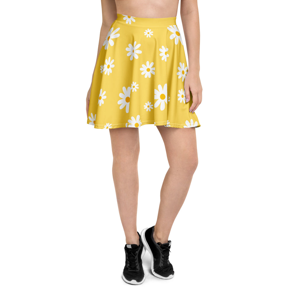 A vibrant yellow pleated women’s skater skirt with white daisies high waisted made from recycled fabric with UPF 50+