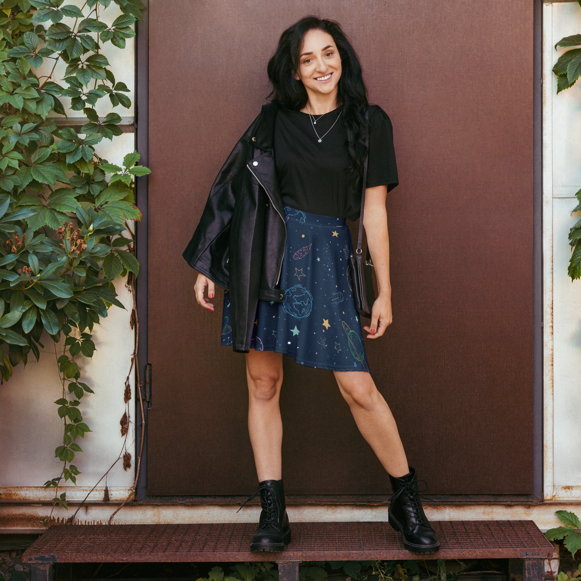 A navy blue womens galaxy space skater mini skirt with gold and white celestial patterns high waisted with upf 50 and recycled fabric