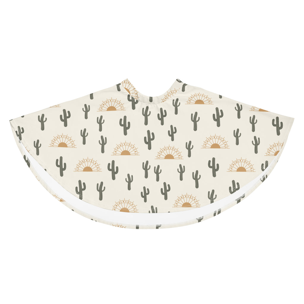 A cream-colored women’s skater skirt with dark green cactus and golden sunset pattern made from recycled fabric with upf 50+