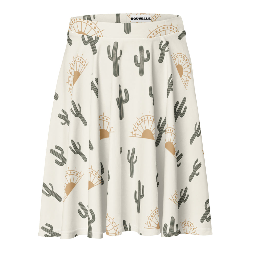 A flowing white women’s desert cactus sunrise skater skirt with gray cactus and tan sun pattern branded bouville