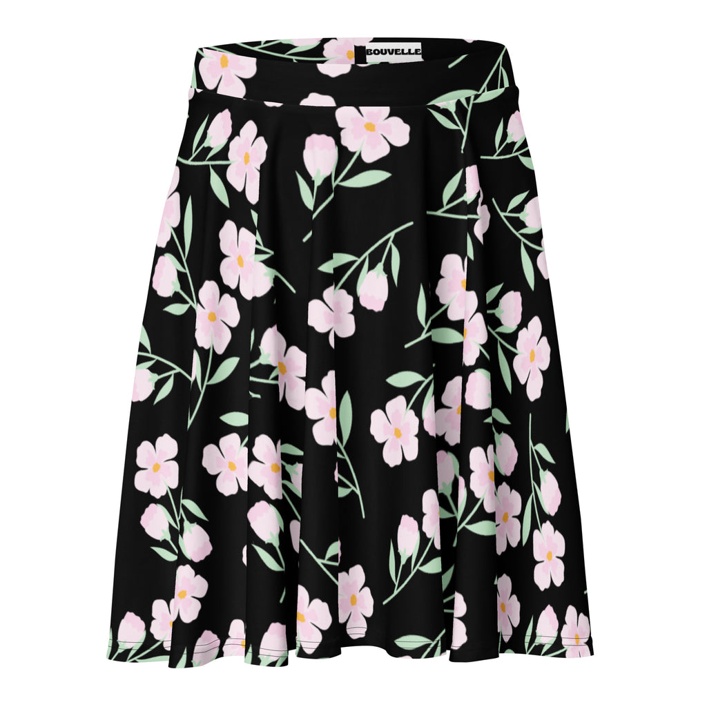 Women’s black floral skater skirt with vibrant pink blossoms and light green stems made from recycled fabric with upf 50+