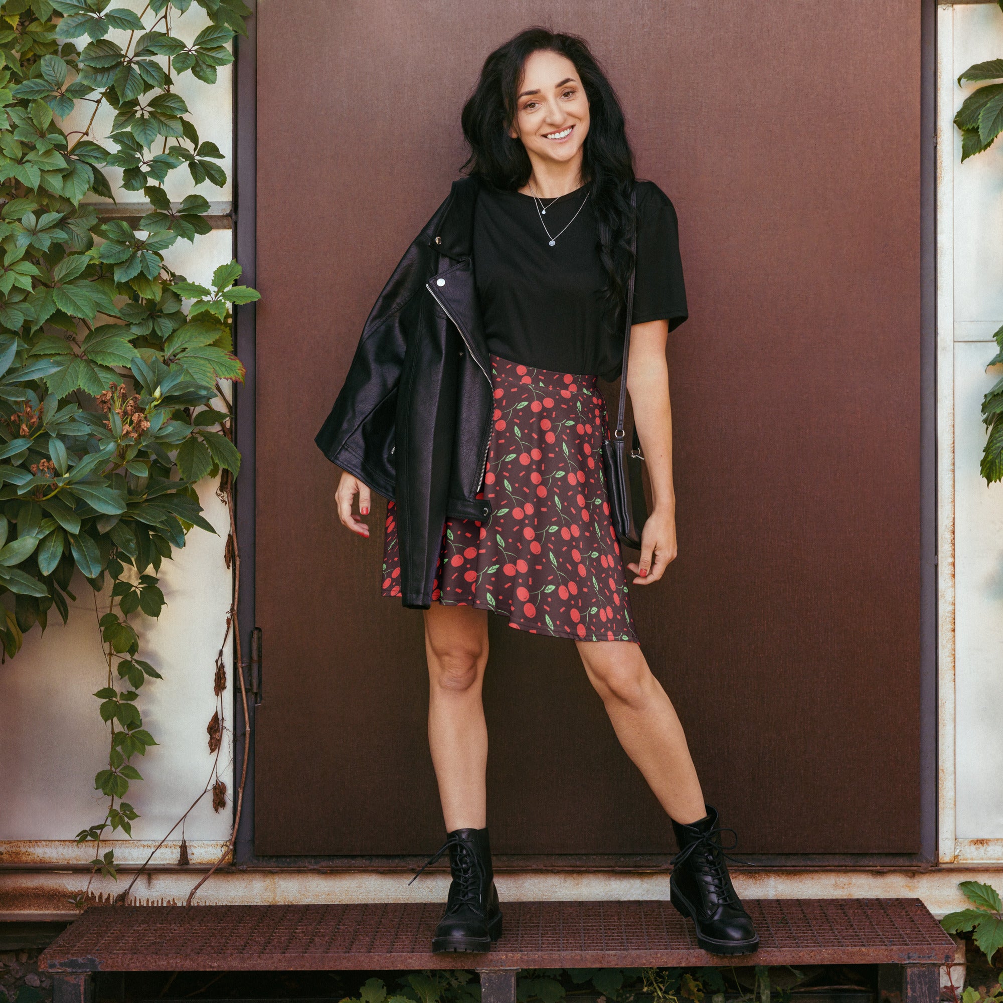 Black leather jacket with zipper detail and shoulder pads paired with women’s dark cherry skater skirt high waisted and flowy