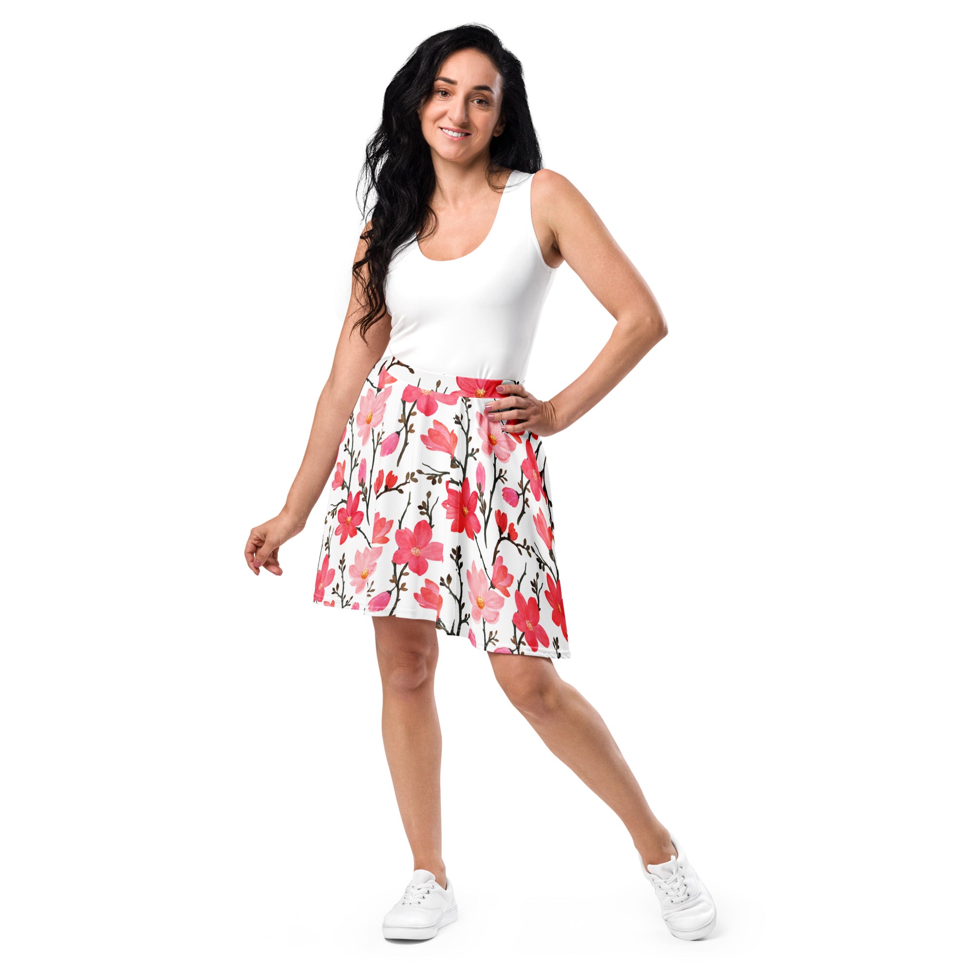 A woman wears a white a-line skater skirt with vibrant pink and red floral patterns on black stems made of recycled fabric