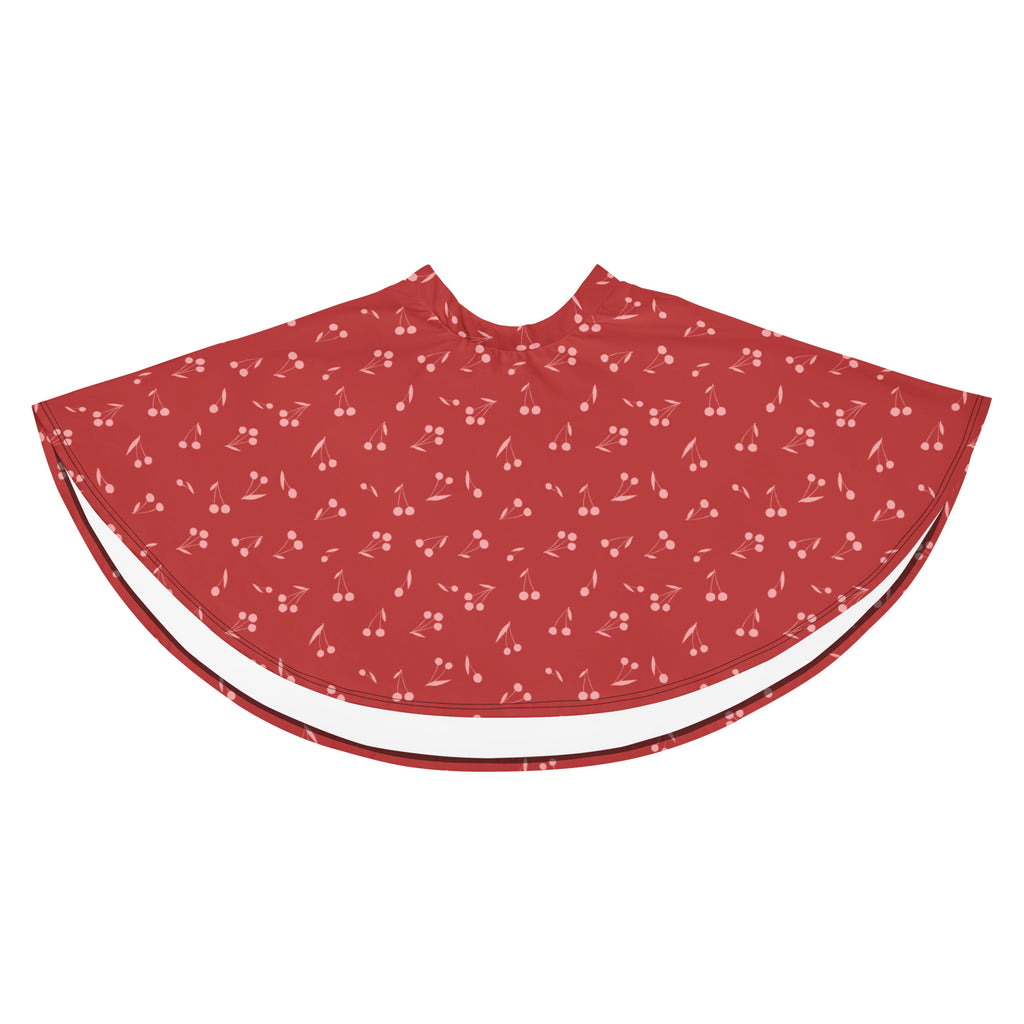 Red cherry patterned cape with white trim made from recycled fabric offering UPF 50 plus sun protection