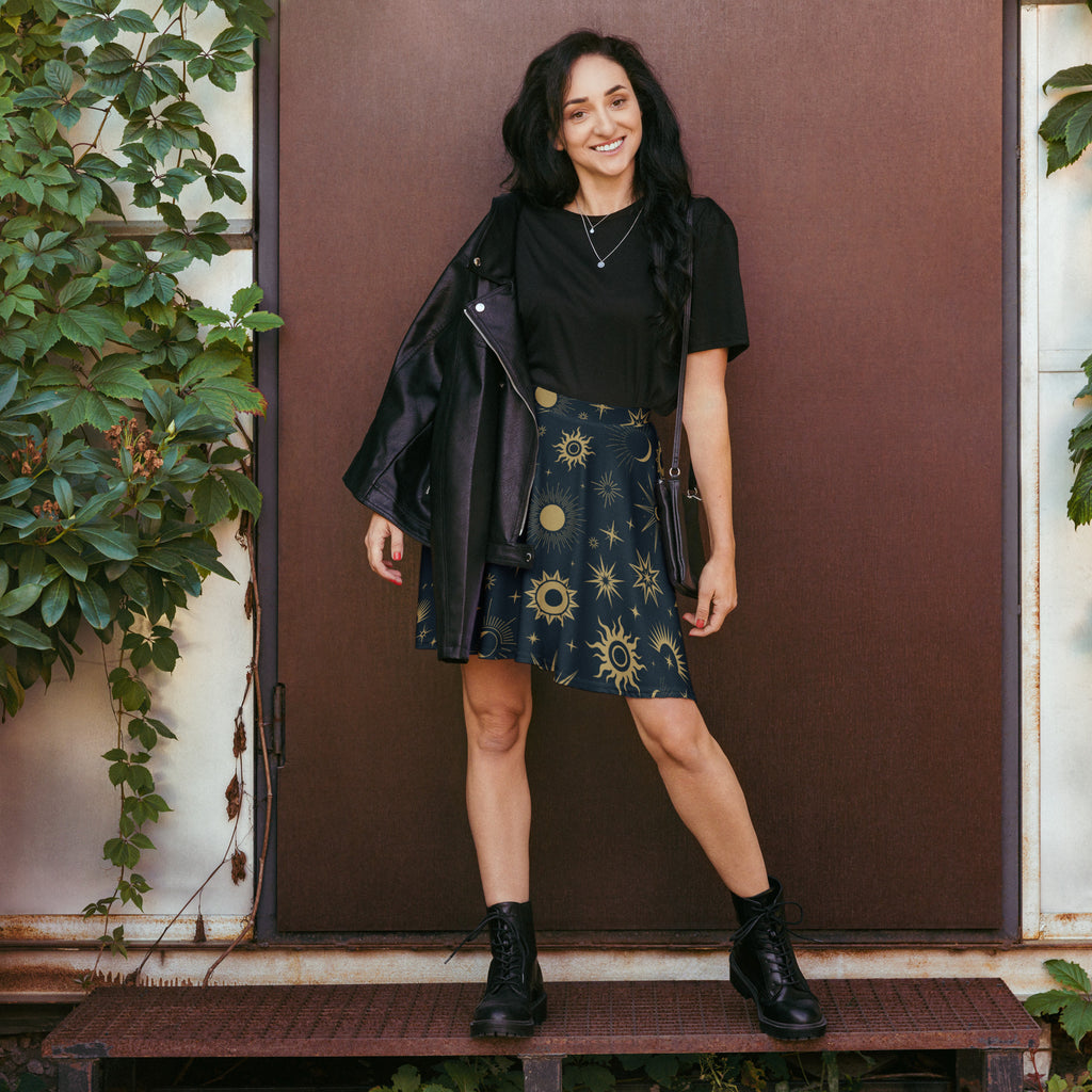 Black leather jacket with gold sun and star patterns paired with women’s celestial sun and moon skater skirt