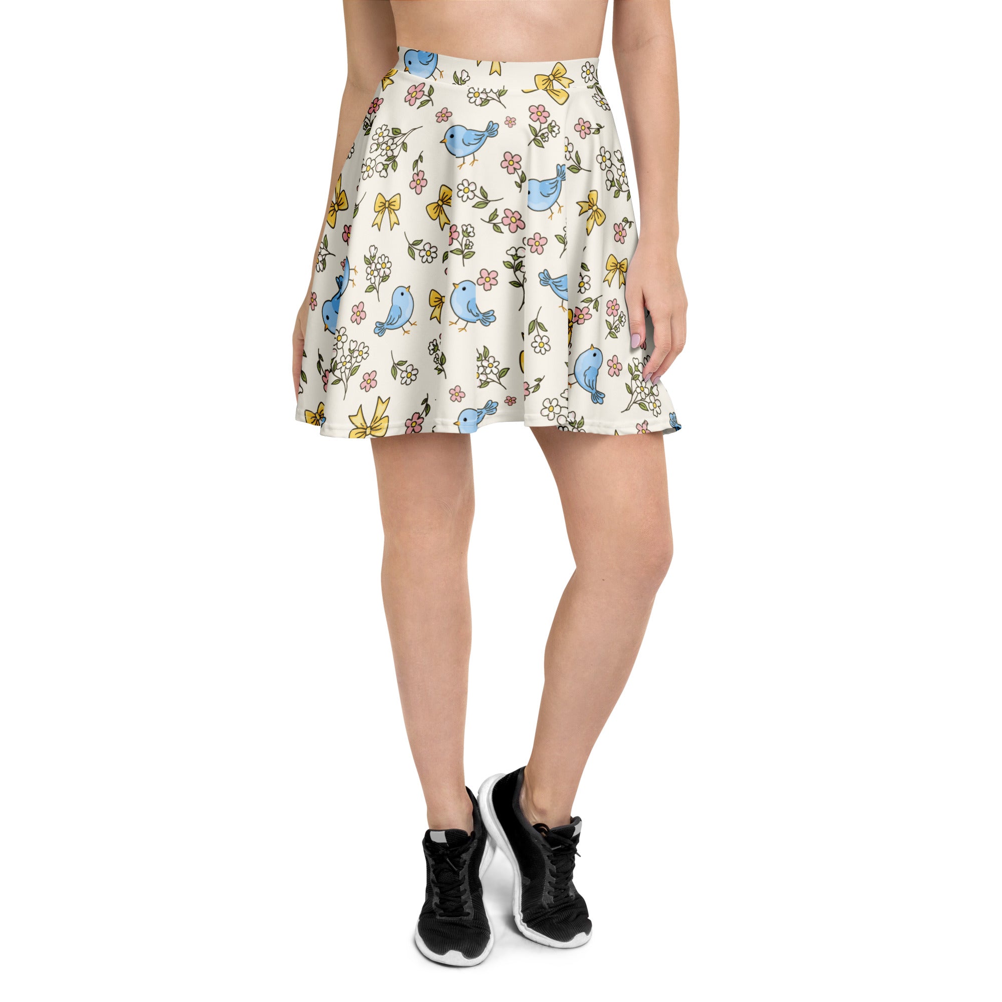 Women’s blue bird skater skirt with playful blue birds yellow bows and pink flowers on off-white recycled fabric with upf 50+