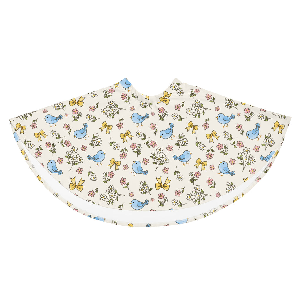 A delicate cream fabric cape with blue birds pink and white flowers and yellow bows complementing women’s blue bird skater skirt