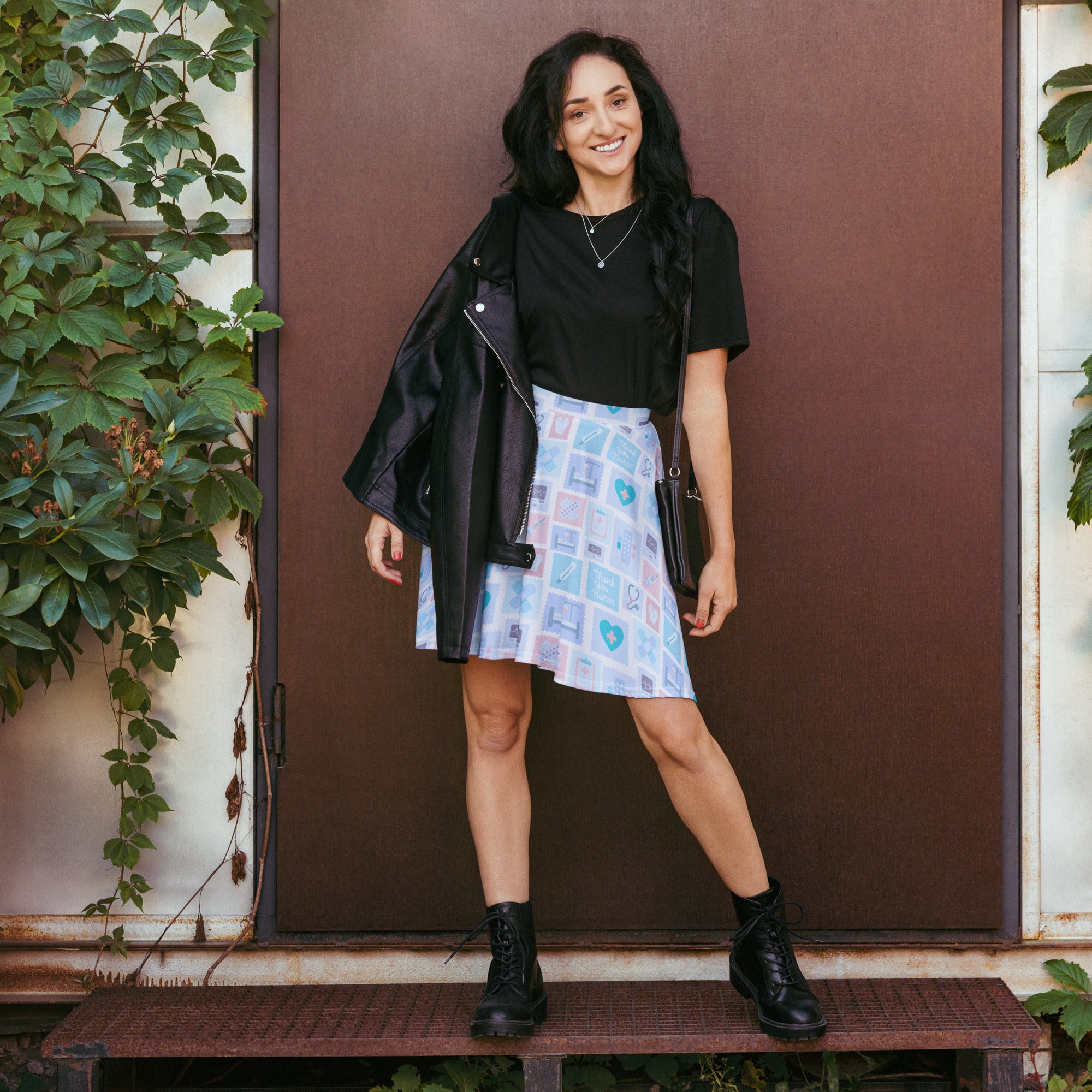 Black leather moto jacket with silver zipper and snap buttons paired with womens blue nurse icon skater skirt