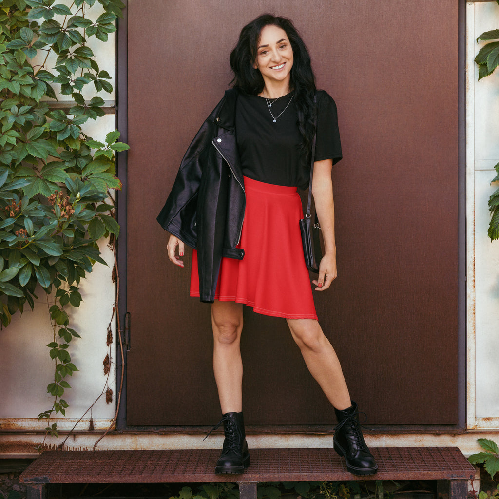 Black leather jacket with zipper details and collar paired with women’s red skater skirt flowy high waisted upf 50 recycled fabric