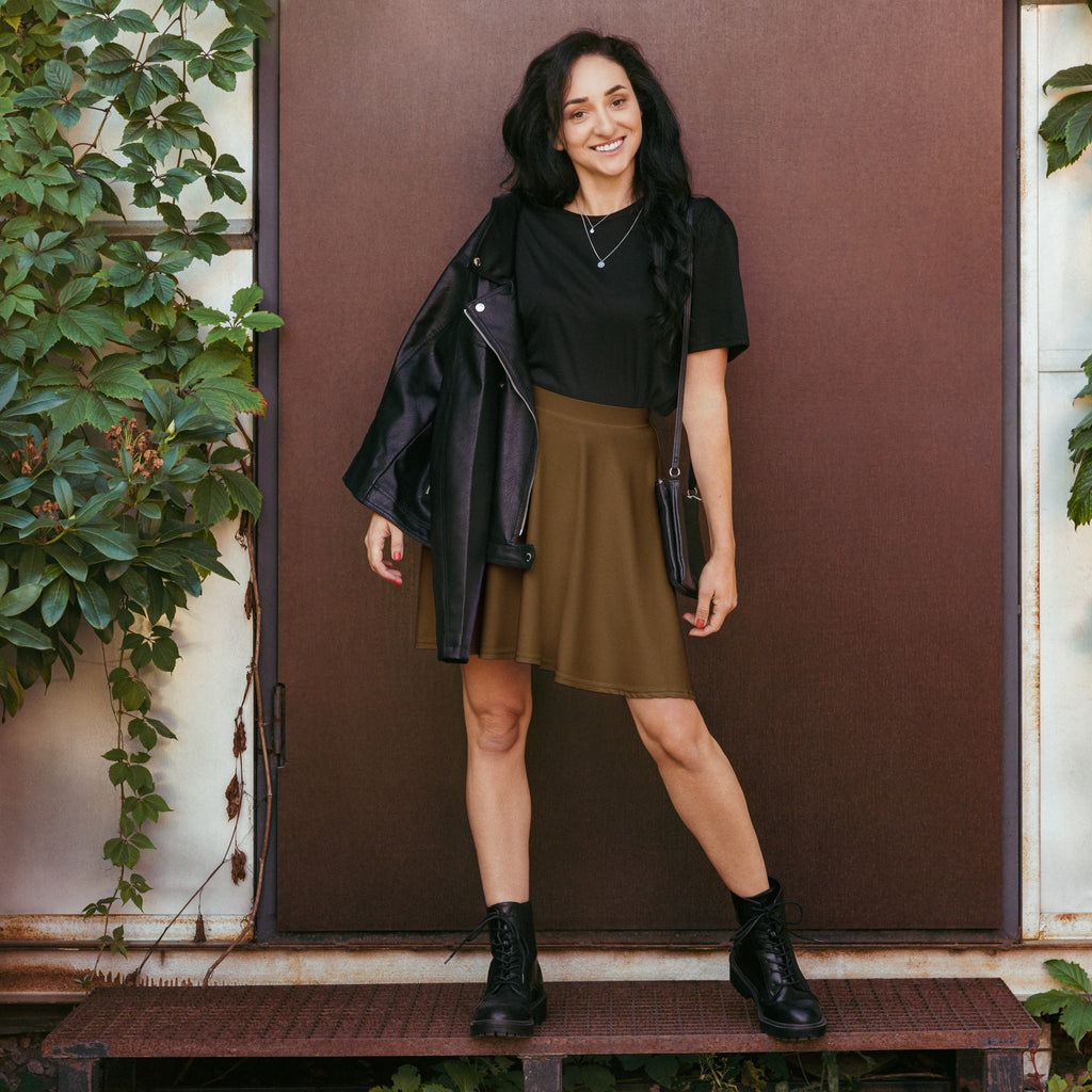 Black leather jacket with silver zipper details paired with women’s brown flowy high waisted skater skirt with UPF 50+