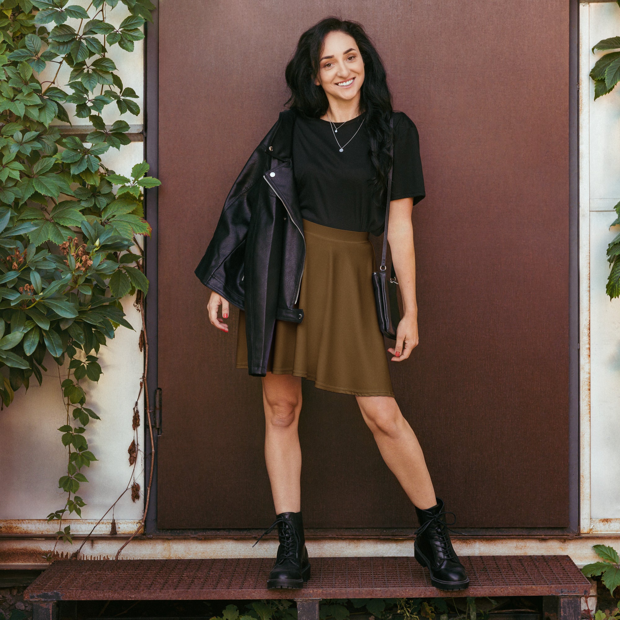 Black leather jacket with silver zipper details paired with women’s brown flowy high waisted skater skirt with UPF 50+