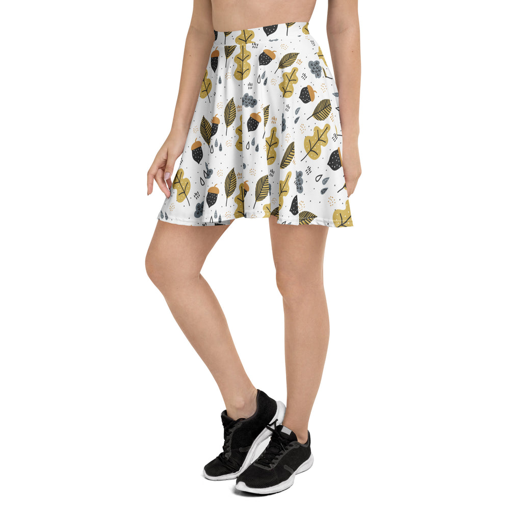 Women’s autumn themed white flared skater skirt with mustard yellow and black leaf pattern made from recycled fabric