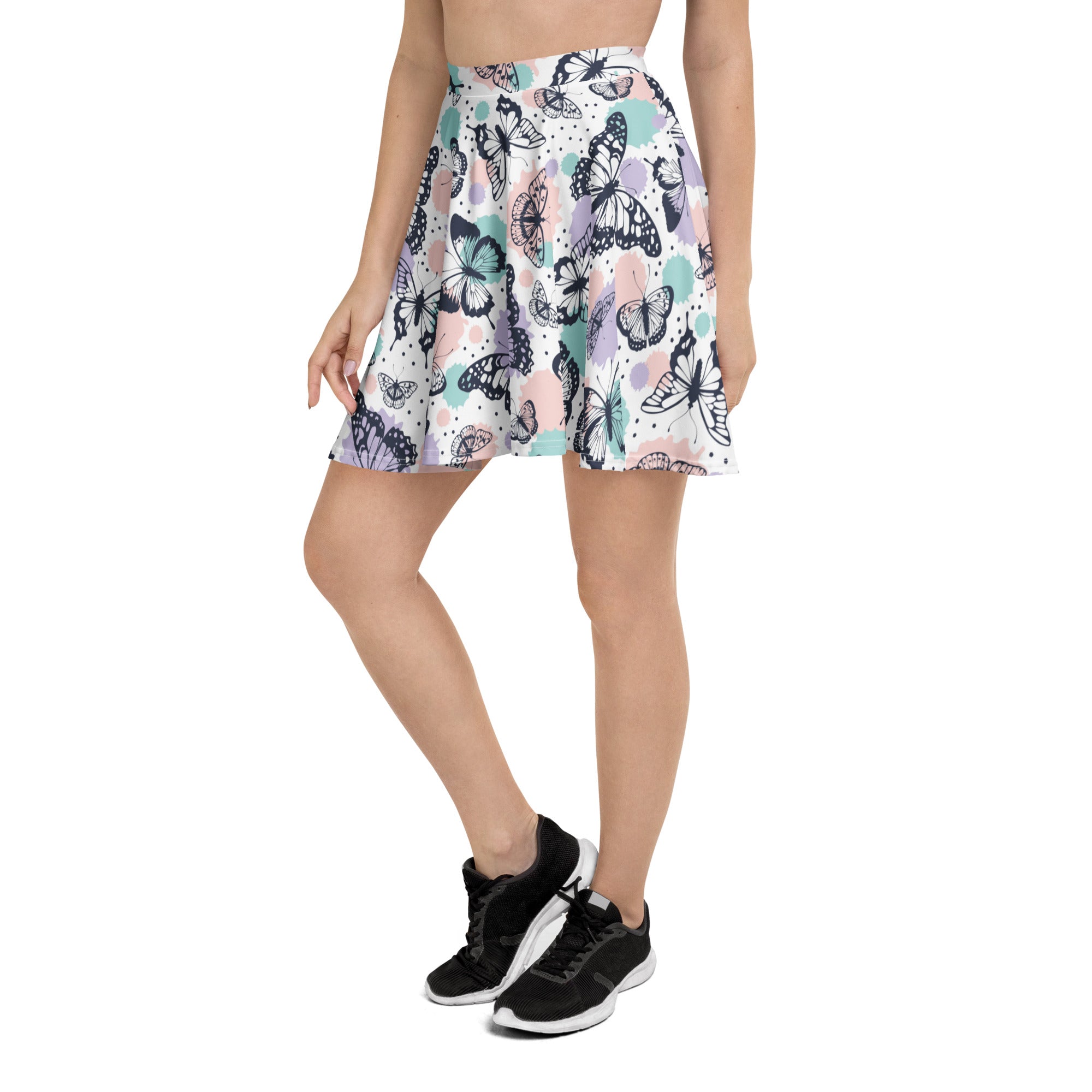 Women’s pastel butterfly skater skirt with vibrant black teal and pink butterfly pattern on white recycled fabric with upf 50+