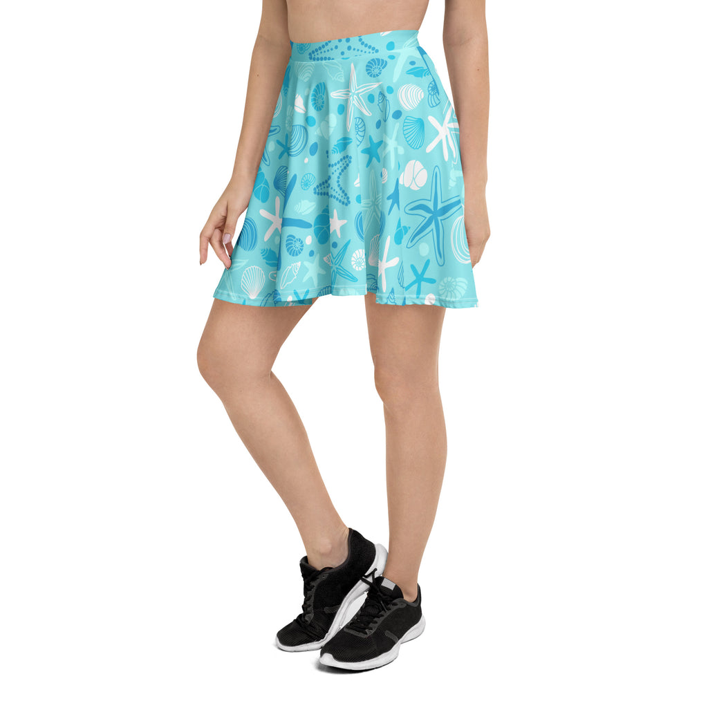 A light blue women’s starfish and shells skater skirt with flowy high waist upf 50 and recycled fabric features playful sea creatures