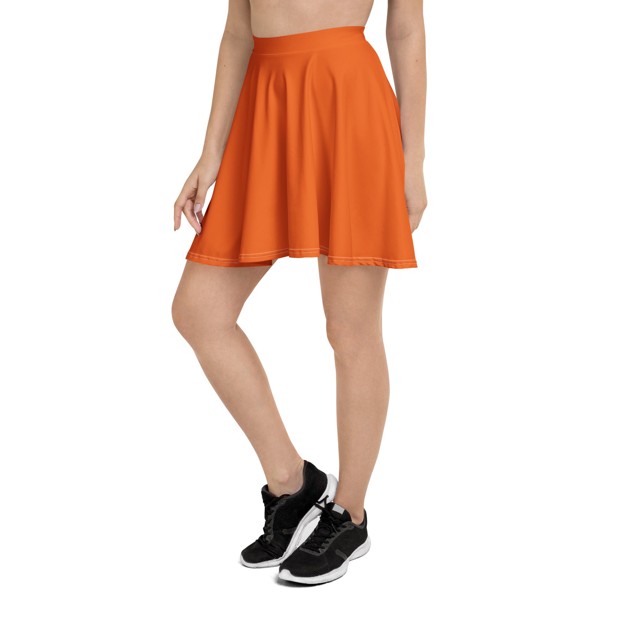 A vibrant orange pleated women’s skater skirt with a high waistband flared hem made from recycled fabric with UPF 50+