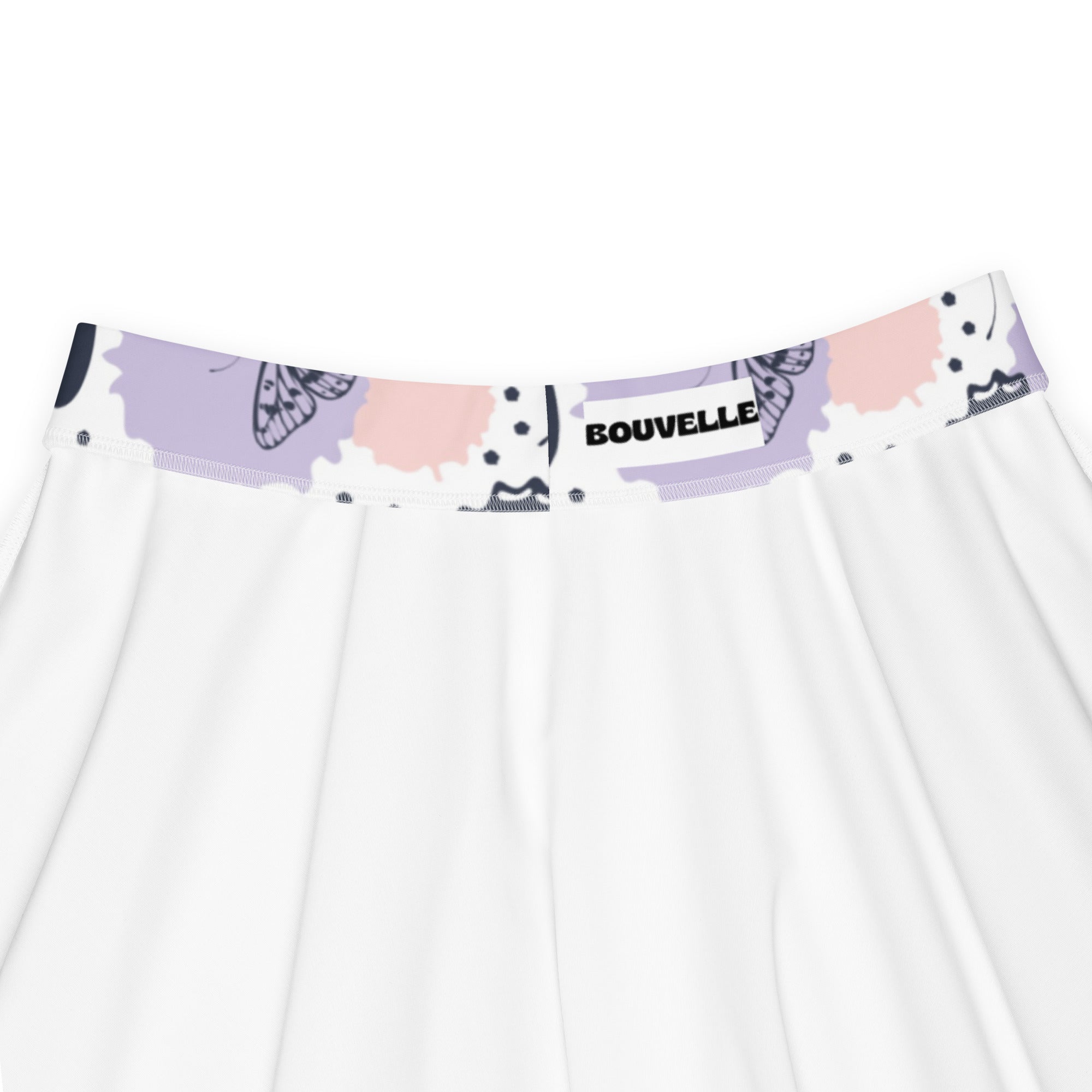 White skirt with lavender and pink butterfly waistband featuring Bouvelle brand label in flowy high waisted design