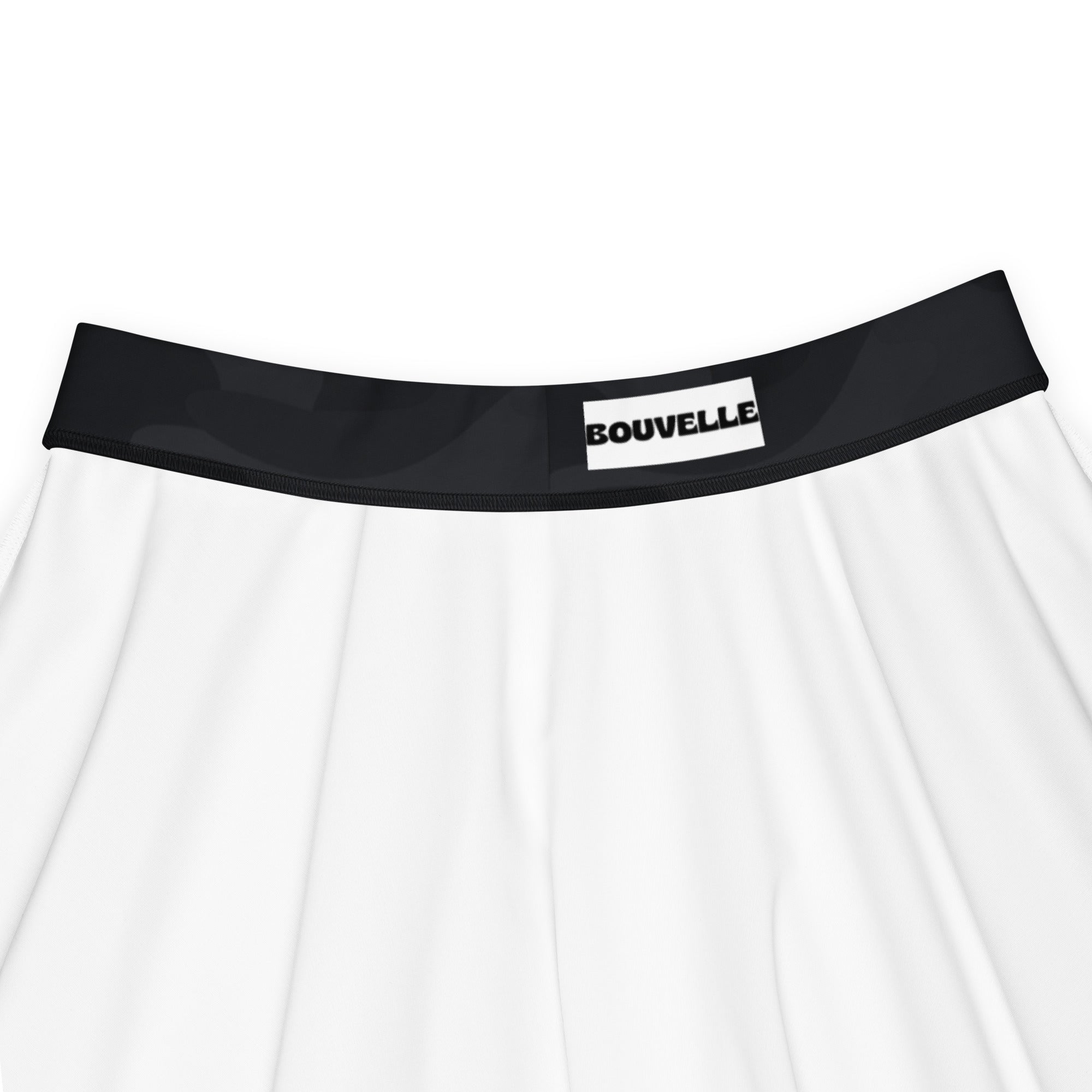 White pleated skirt with black elastic waistband featuring bouvelle label paired with women’s black camouflage skater skirt