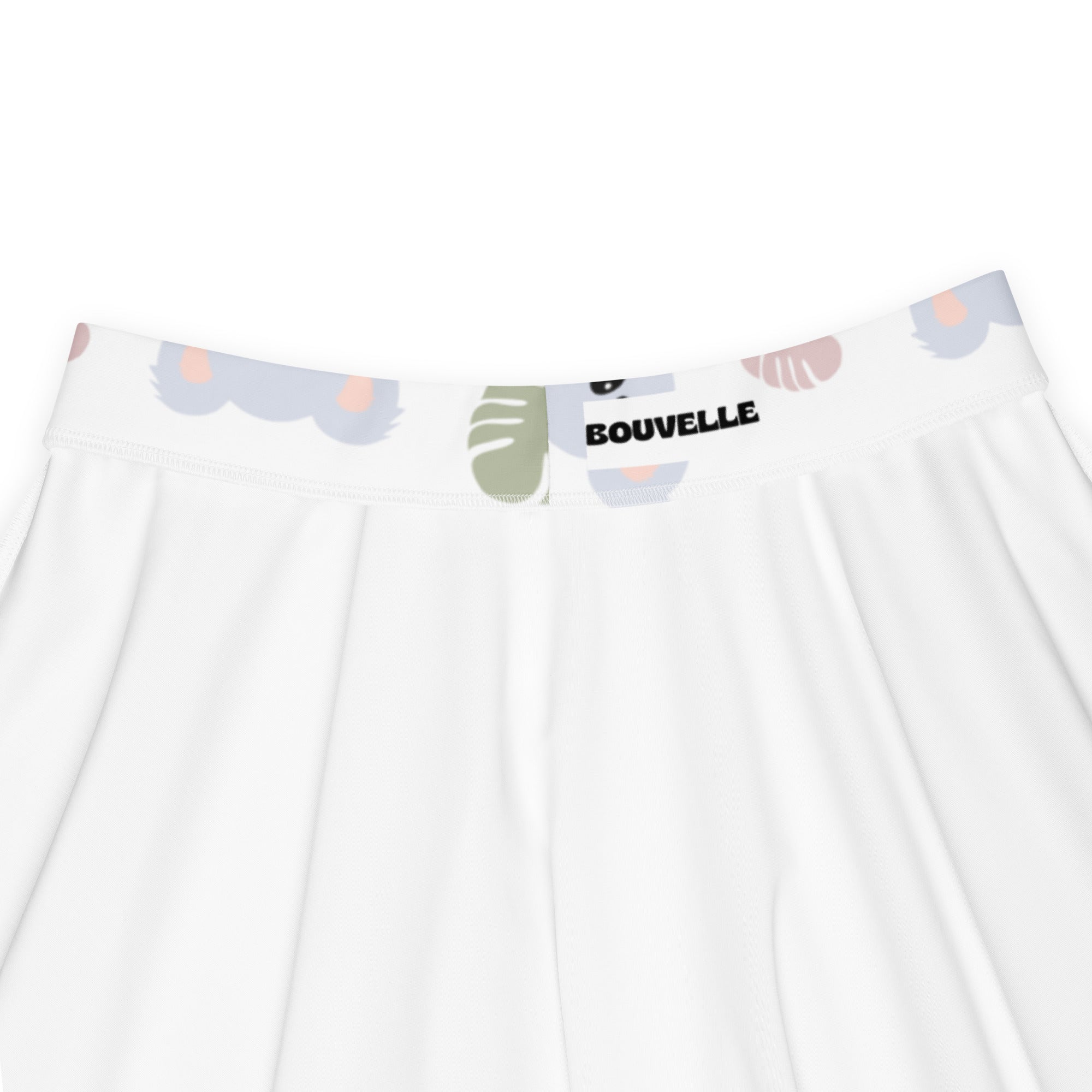 White pleated skater skirt with waistband featuring pastel animal and leaf prints by bouvelle with upf 50+ recycled fabric