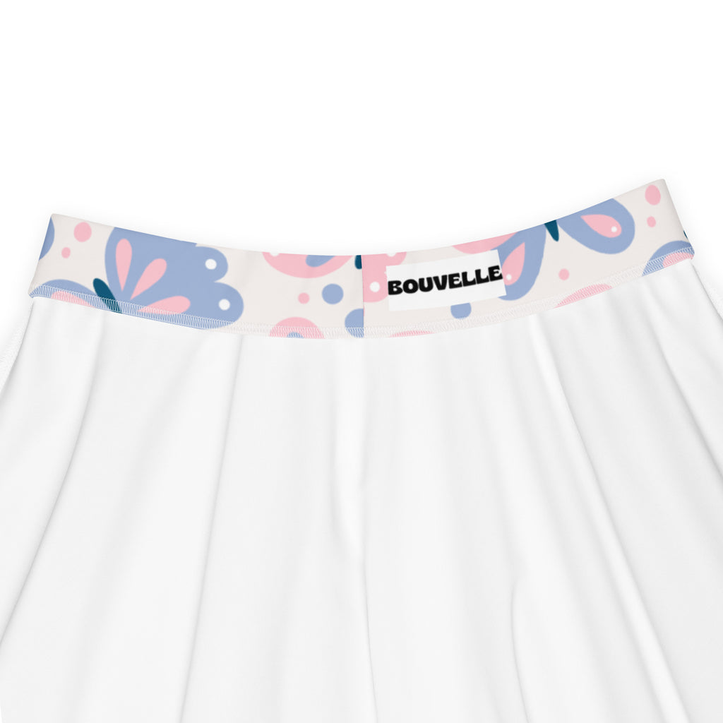 White women’s butterfly print skater skirt with colorful floral waistband pink and blue patterns upf 50 plus recycled fabric