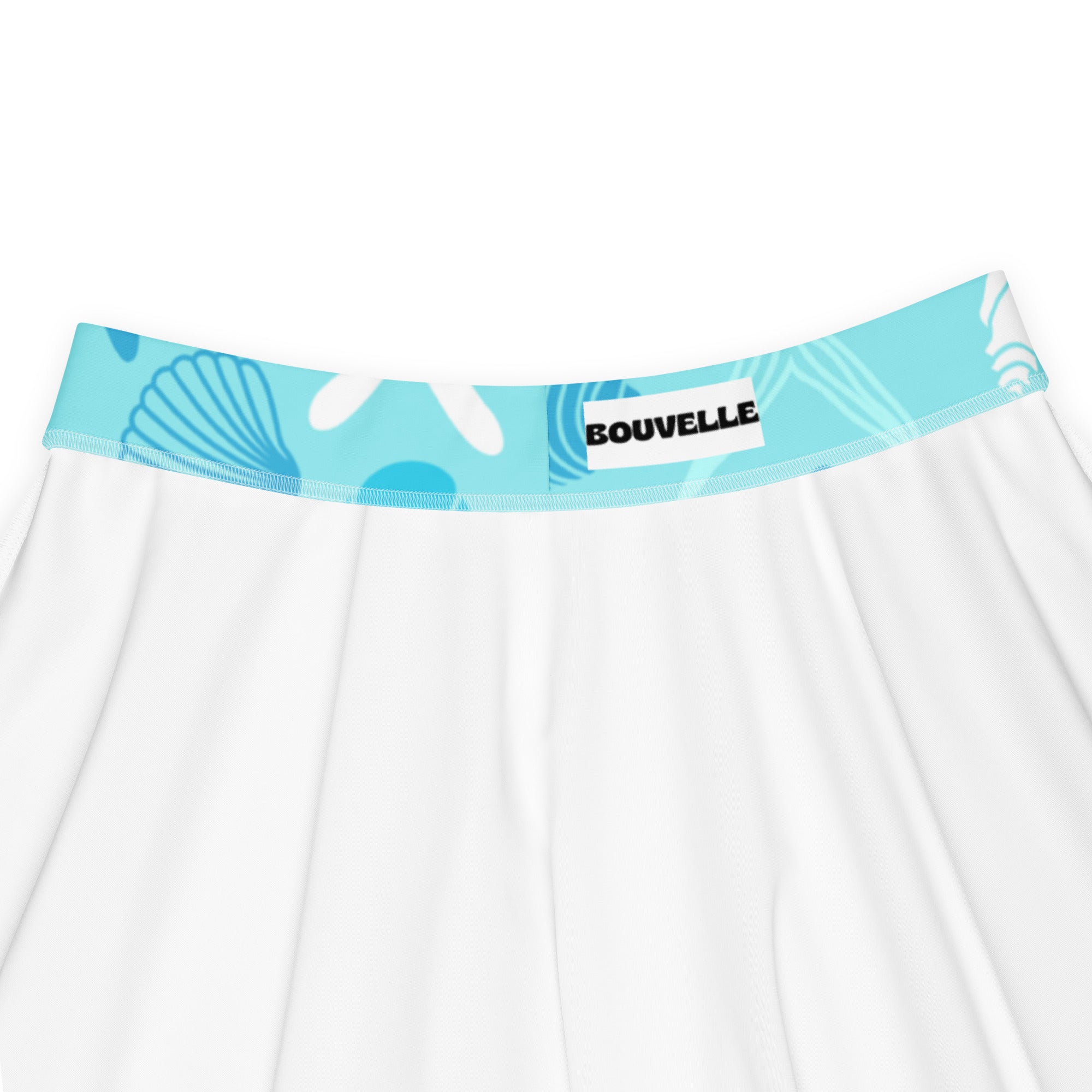 White skirt with light blue elastic waistband featuring seashell coral patterns branded bouvelle recycled fabric upf 50+