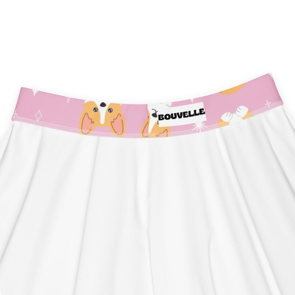 Pink waistband with cartoon corgi faces and bouvelle label on white fabric of women’s pink corgi dog skater skirt