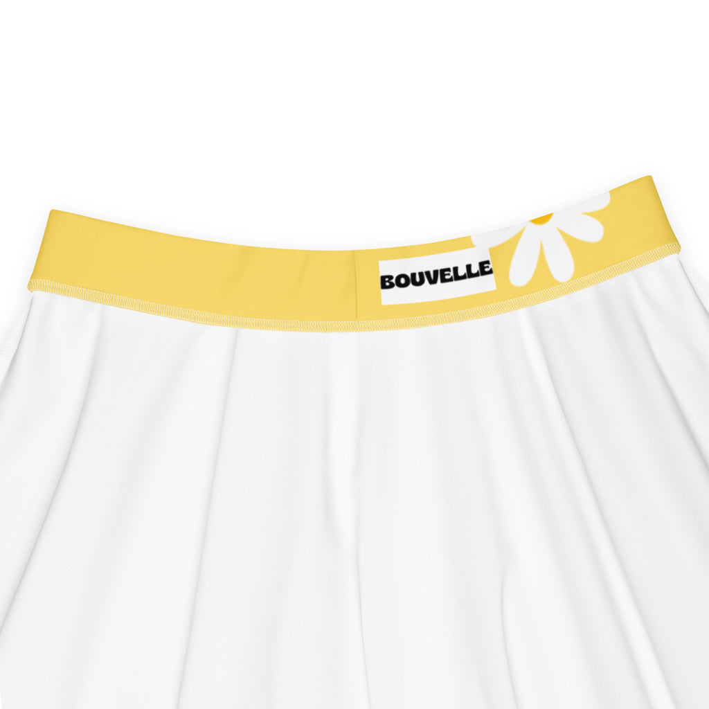 White skater skirt with bright yellow elastic waistband featuring bouvelle brand name and white daisy graphic