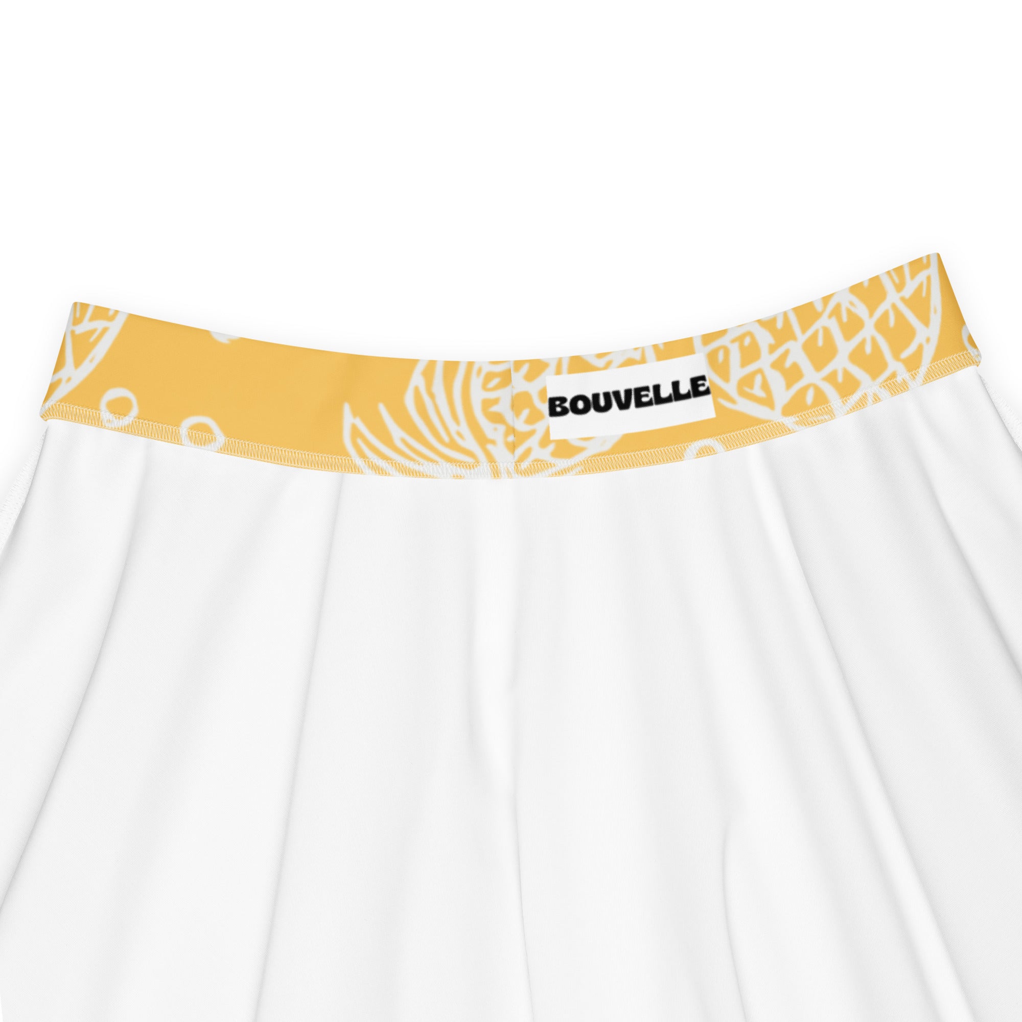 White skirt with yellow waistband and white tropical leaf patterns by bouvelle made from recycled fabric with upf 50+