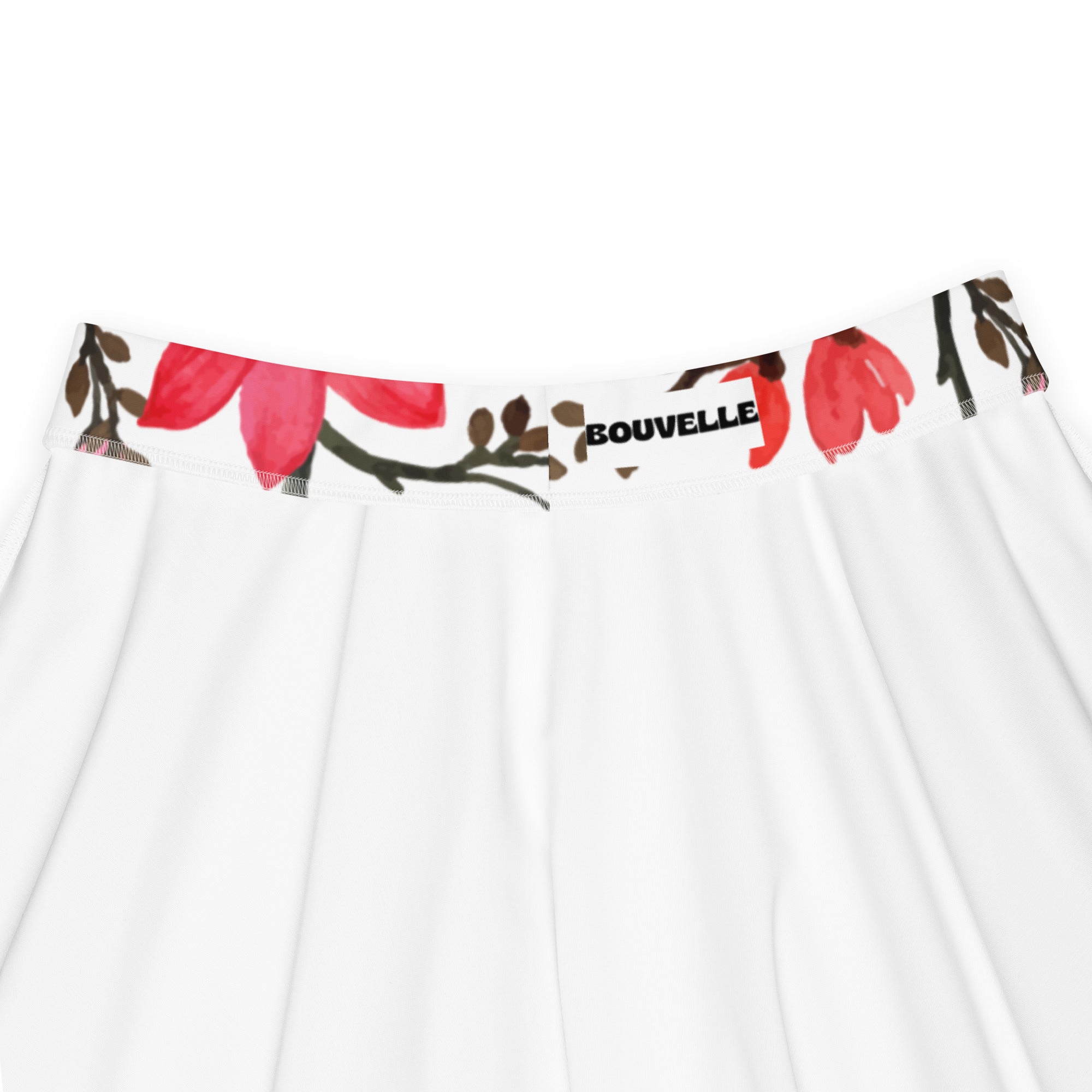 White skirt with vibrant red floral waistband featuring bouvelle label in a flowy high waisted skater style with recycled fabric