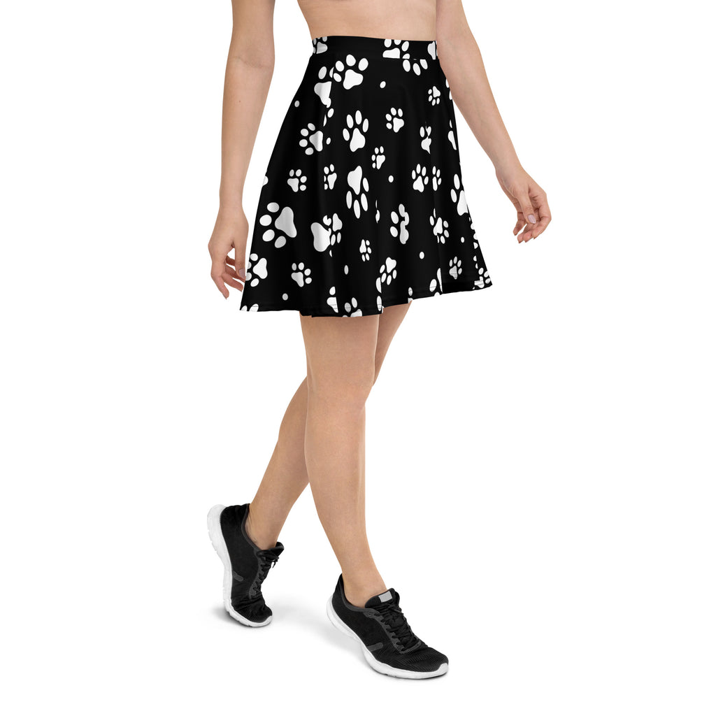 Black pleated women’s skater skirt with white paw prints made from recycled fabric with UPF 50 plus protection