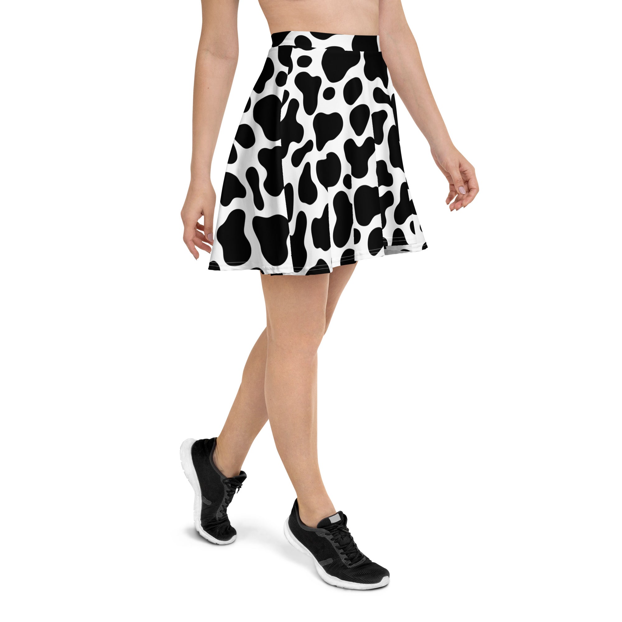 Women’s black and white cow print skater skirt with flared high waist made from recycled fabric and upf 50+ protection
