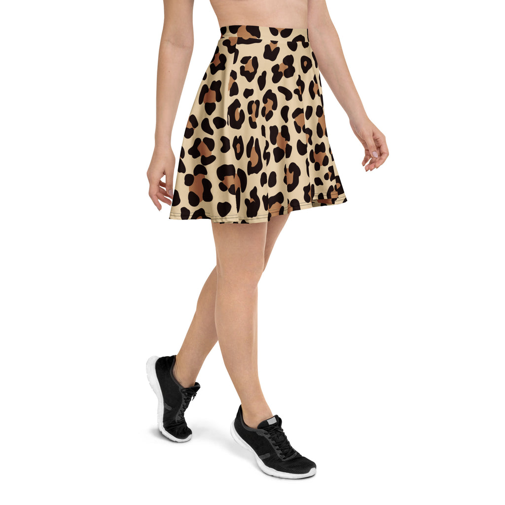 A women’s leopard print skater skirt with a beige base, bold black and brown pattern, flowy high waisted with UPF 50+ and recycled fabric