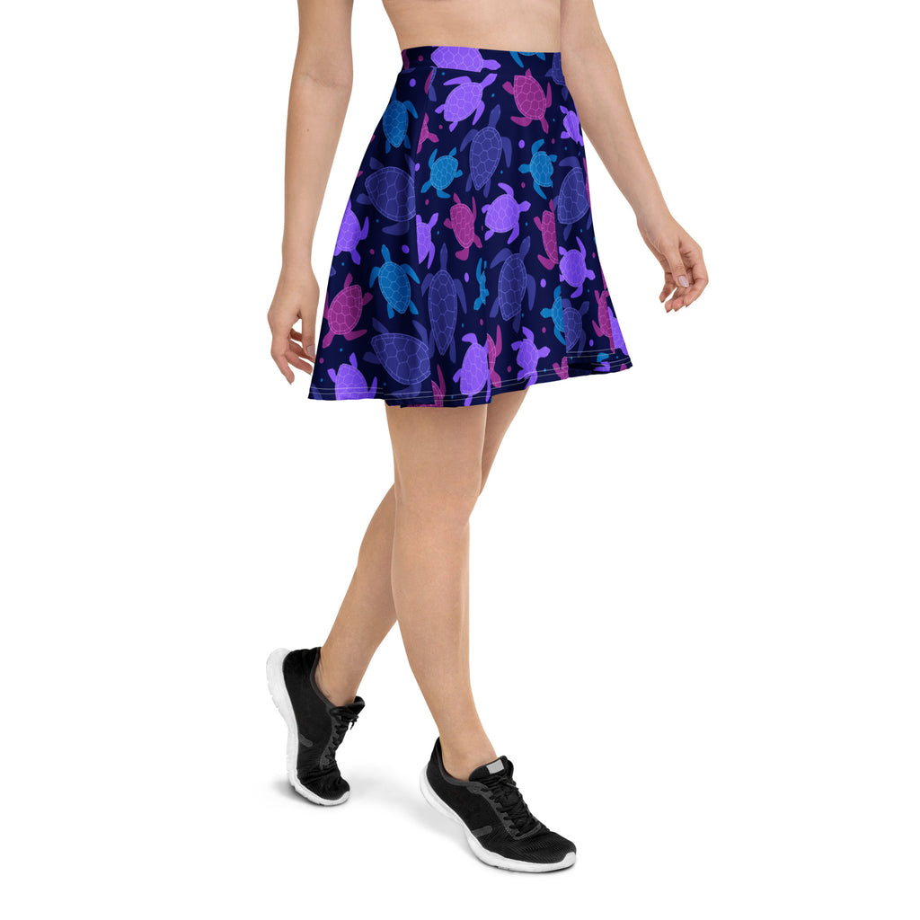 Women’s purple sea turtle skater skirt in navy blue pleated design with vibrant sea turtle pattern and upf 50 plus recycled fabric