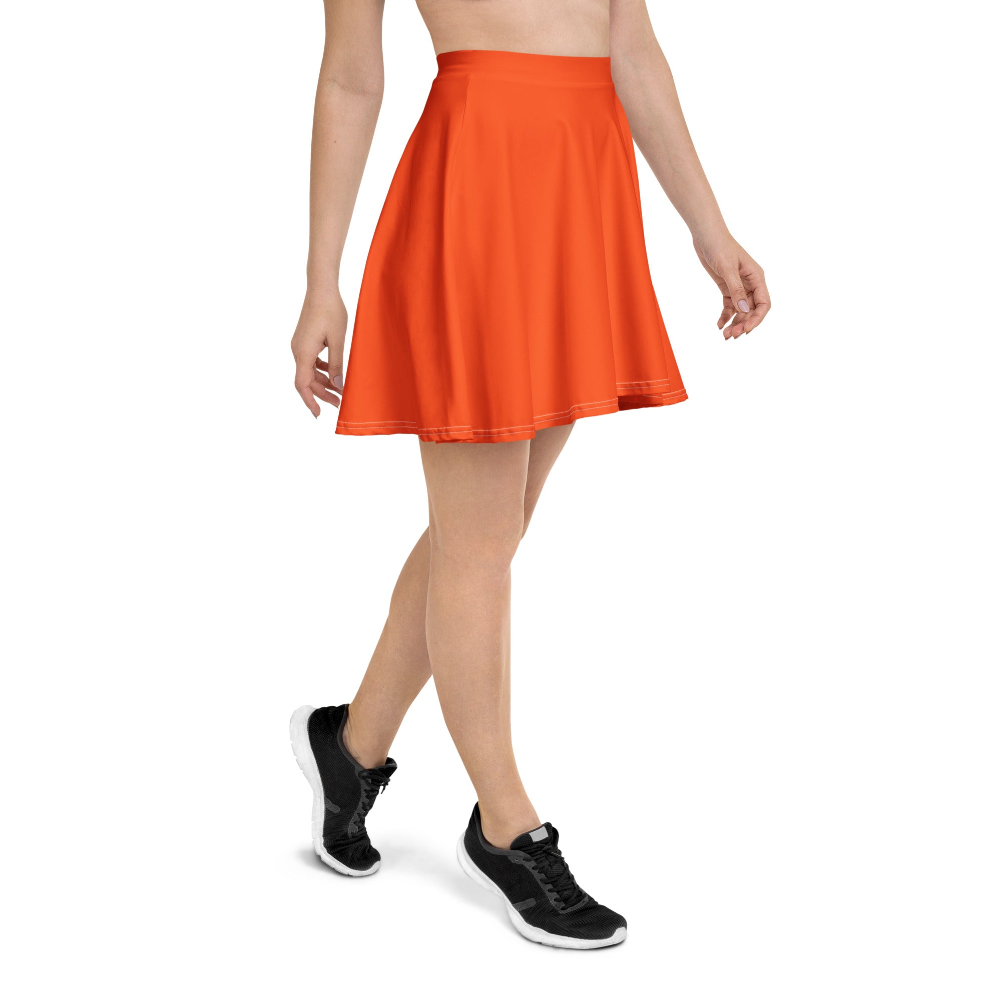 A vibrant orange pleated skater skirt with a fitted waistband flared hem made from recycled fabric with UPF 50+ protection