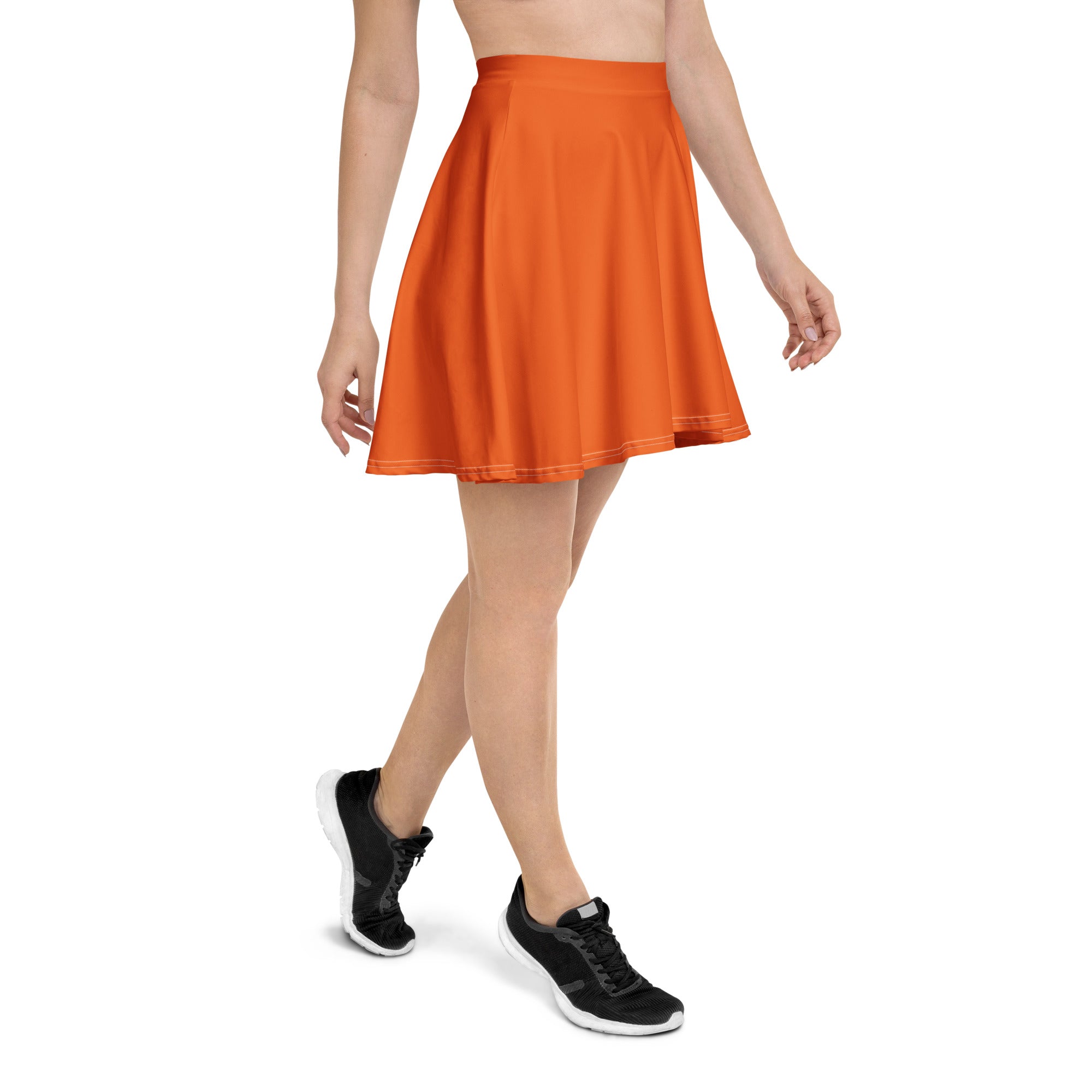 A vibrant orange pleated skater skirt with fitted waistband flared hem made from recycled fabric with UPF 50+ protection