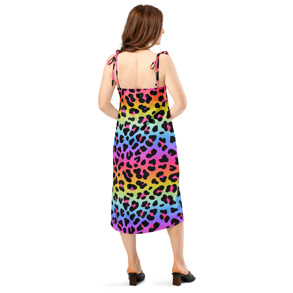 Woman wearing a colorful leopard print dress on a white background