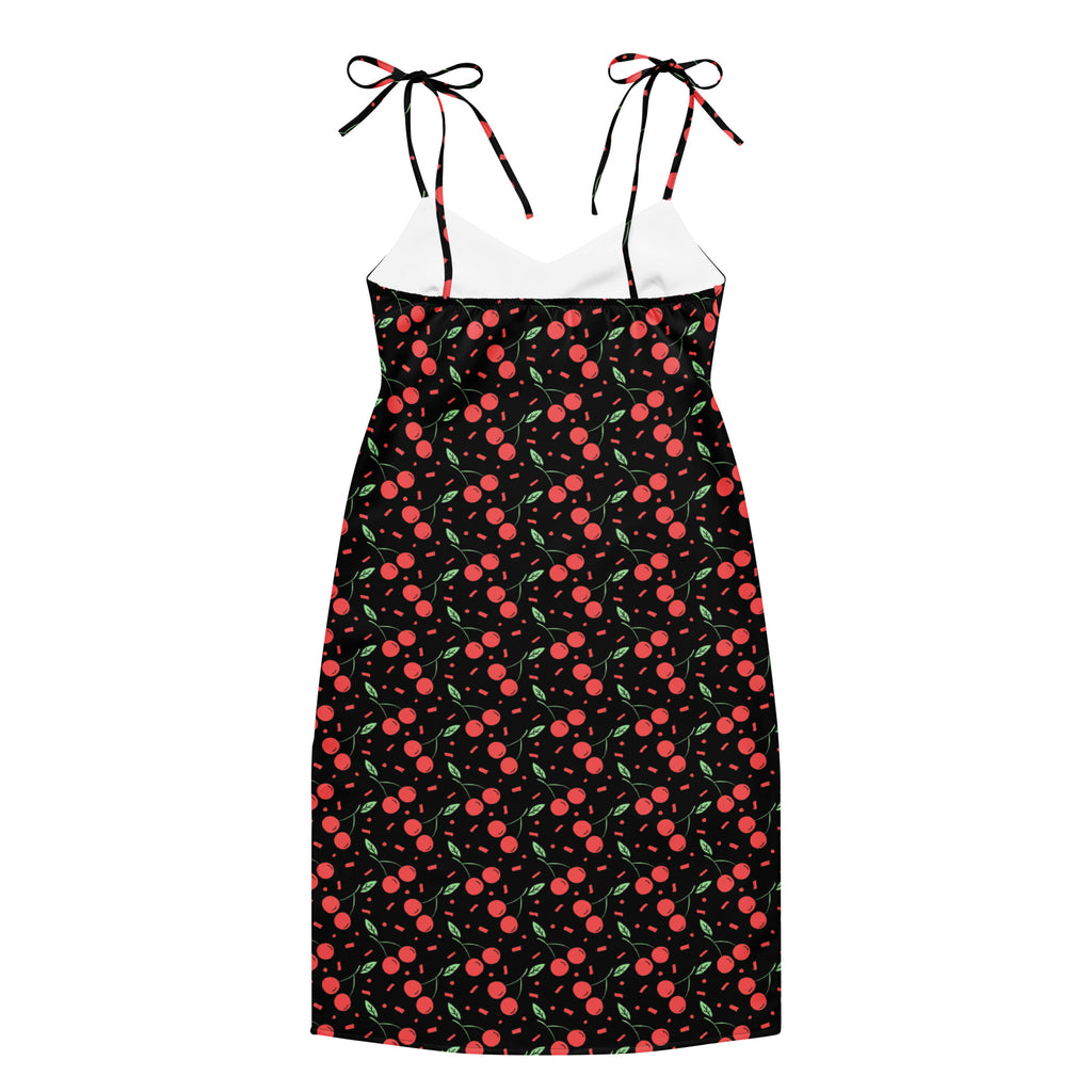 Women’s black mini cherry slip dress with red cherry print, adjustable tie straps, and built-in bra on dark background