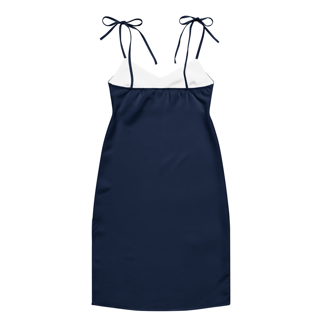 Women's navy blue slip dress with white neckline panel, adjustable tie straps, built-in bra, midi length.