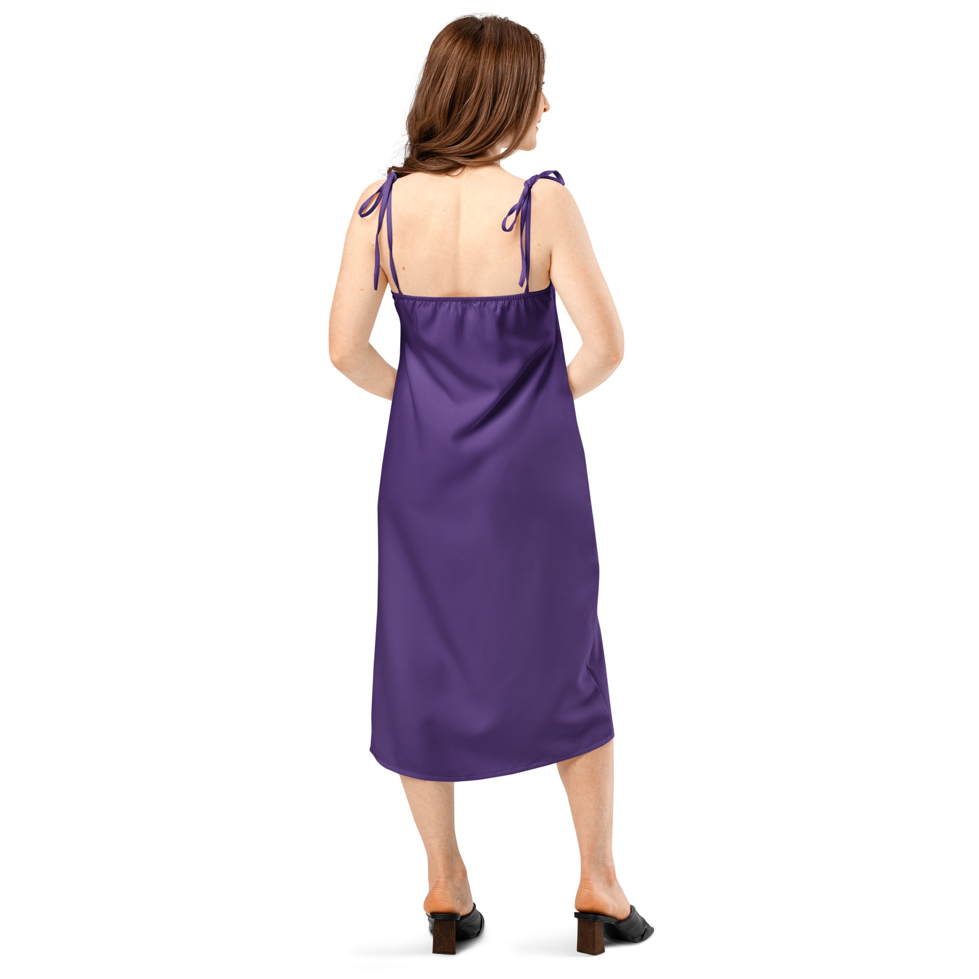 Woman wearing a purple satin slip dress on a white background
