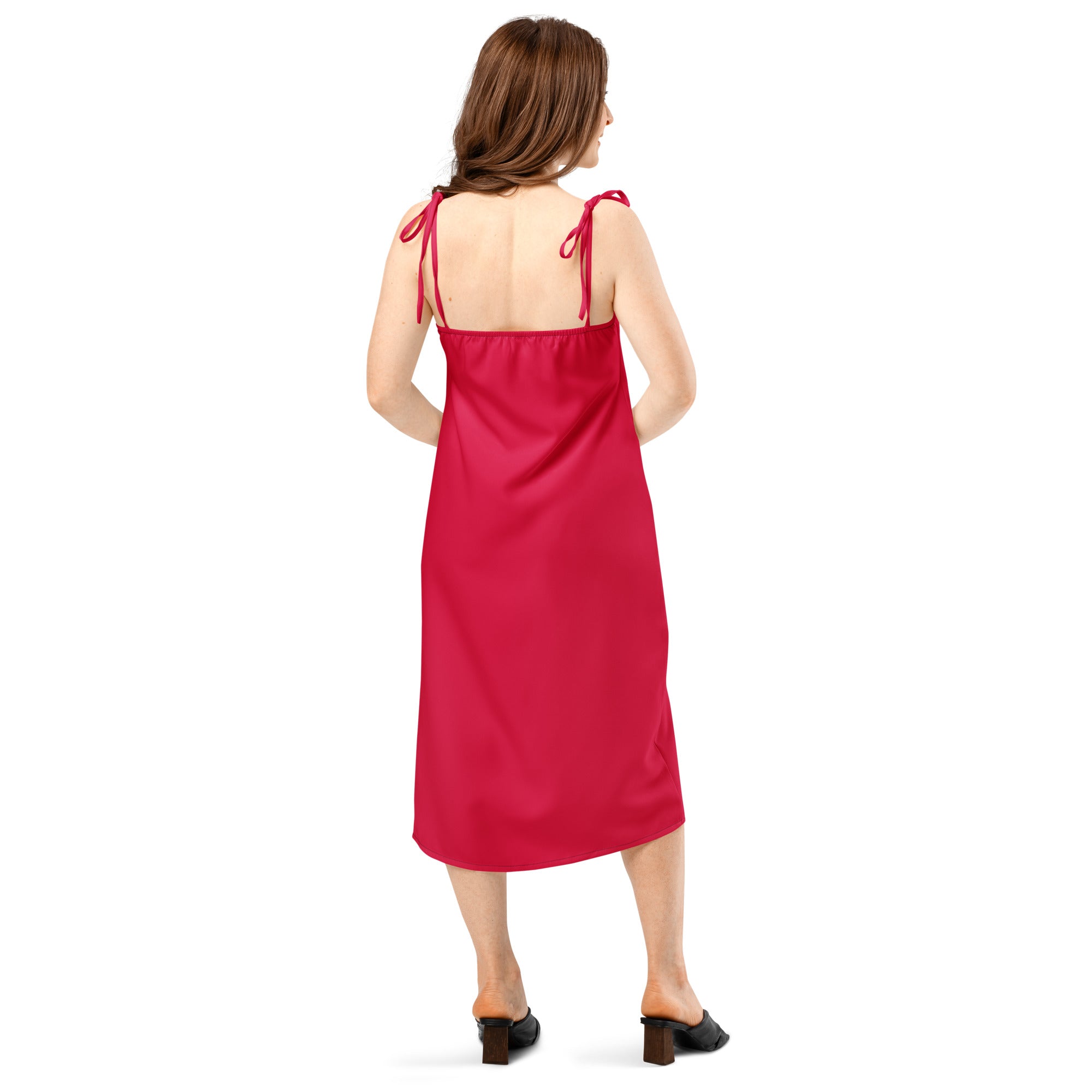 Woman wearing a red dress with thin straps on a white background
